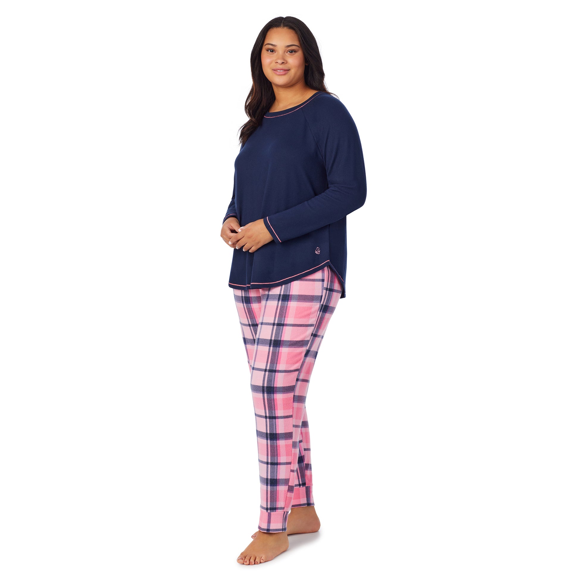 A lady wearing pink plaid brushed sweater knit long sleeve plus pajama set.