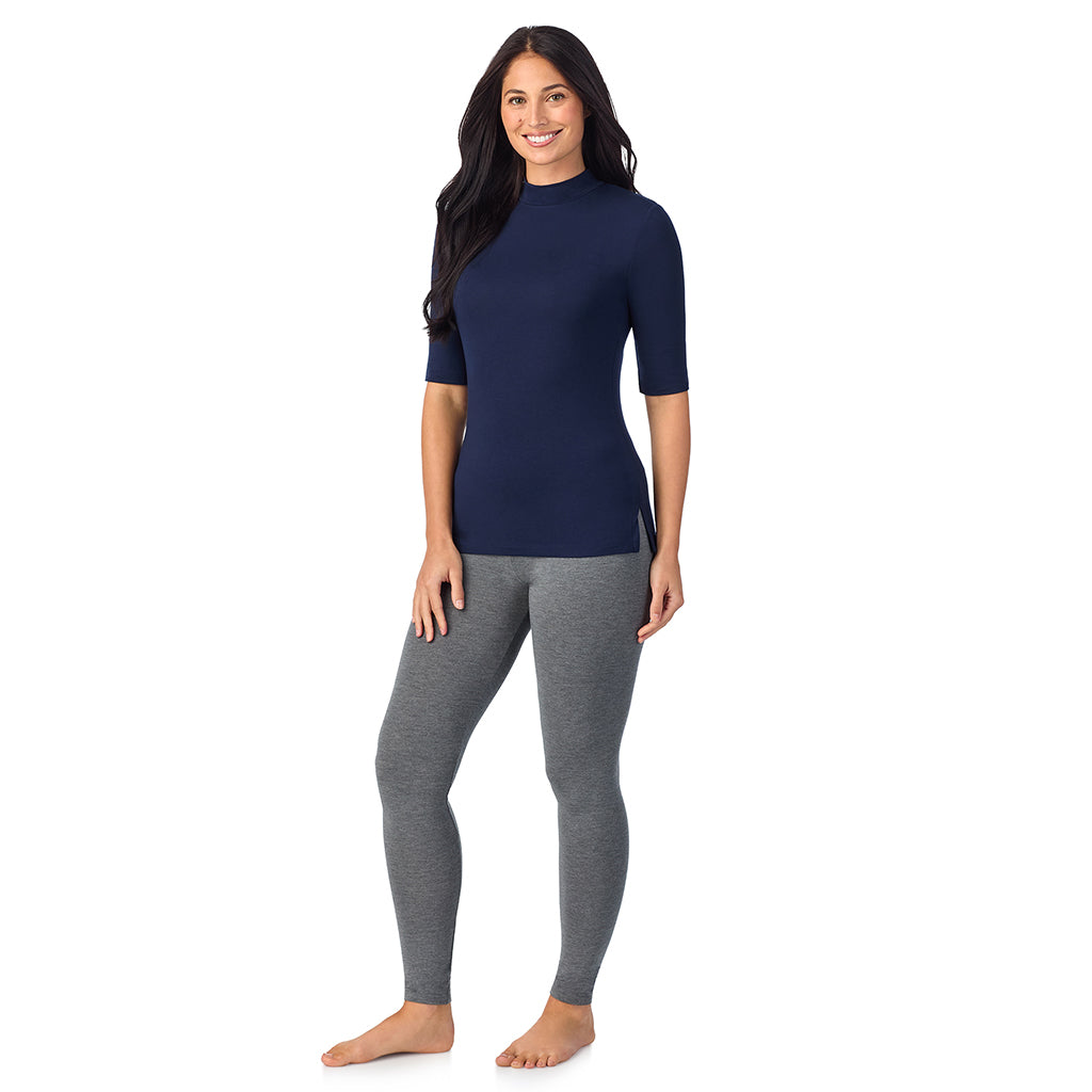 A lady wearing a blue elbow sleeve mock neck.