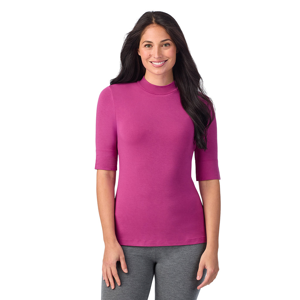 Baton Rouge; Model is wearing size S. She is 5'8.5", Bust 32", Waist 25", Hips 36".@A lady wearing a pink elbow sleeve mock neck.
