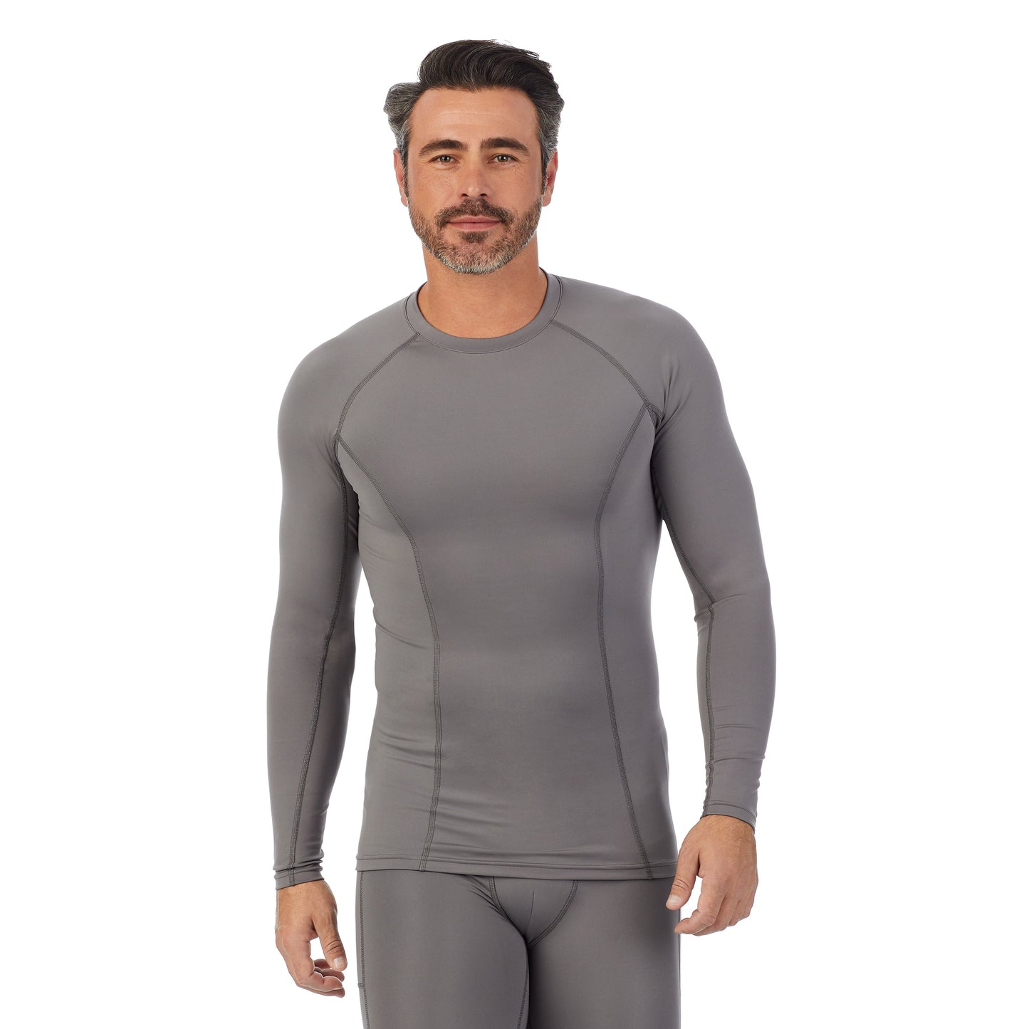 Nickel Grey; Model is wearing size M. He is 6'2", Waist 32", Inseam 34". @A man wearing Nickel Grey Lite Compression Long Sleeve Crew