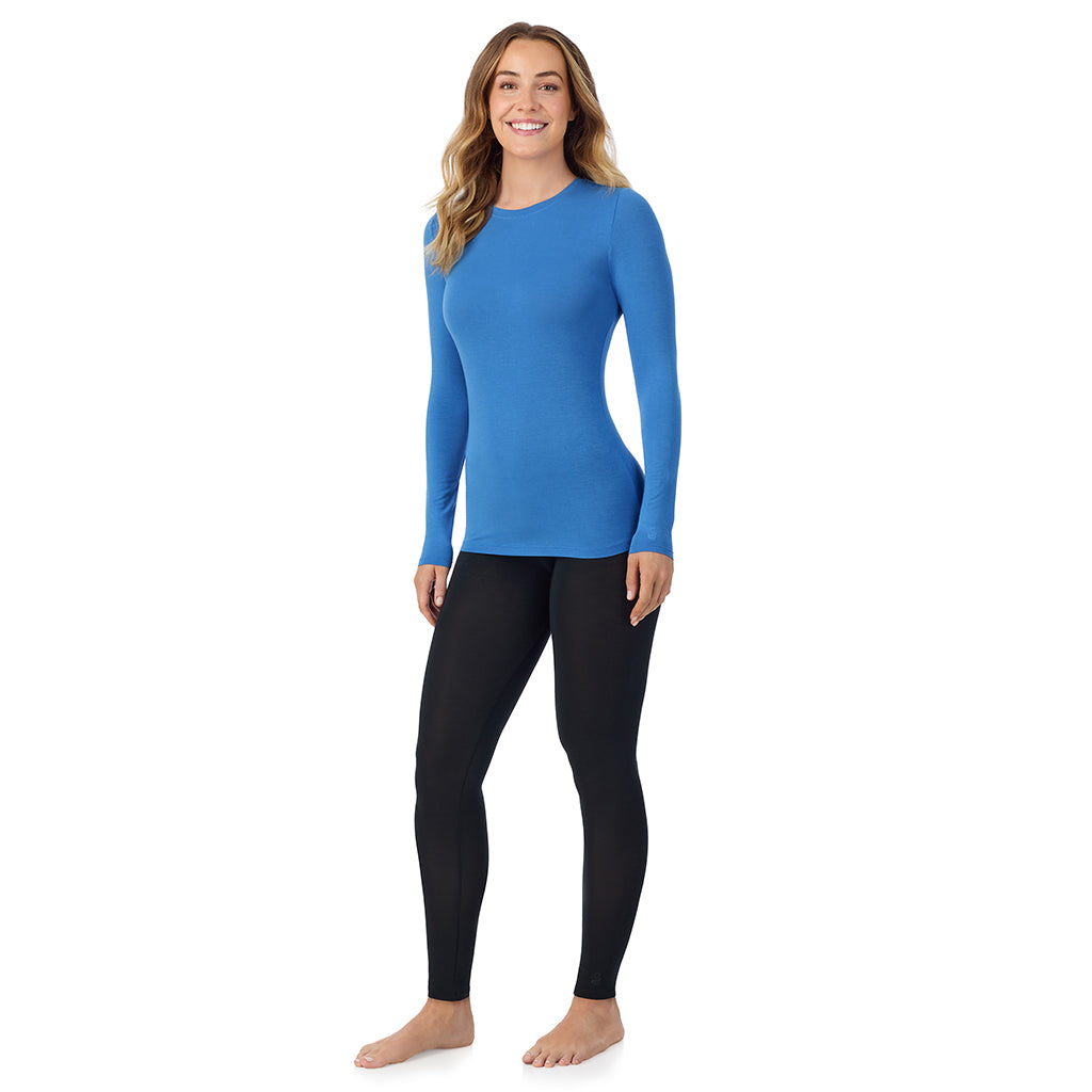 Blue Comet; Model is wearing size S. She is 5'11.5", Bust 34", Waist 26", Hips 37". @A lady wearing a blue comet long sleeve stretch crew.