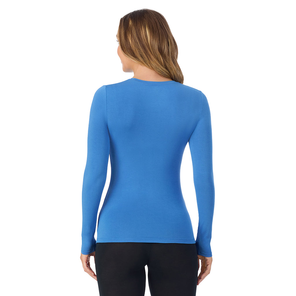 Blue Comet; Model is wearing size S. She is 5'11.5", Bust 34", Waist 26", Hips 37". @A lady wearing a blue comet long sleeve stretch crew.