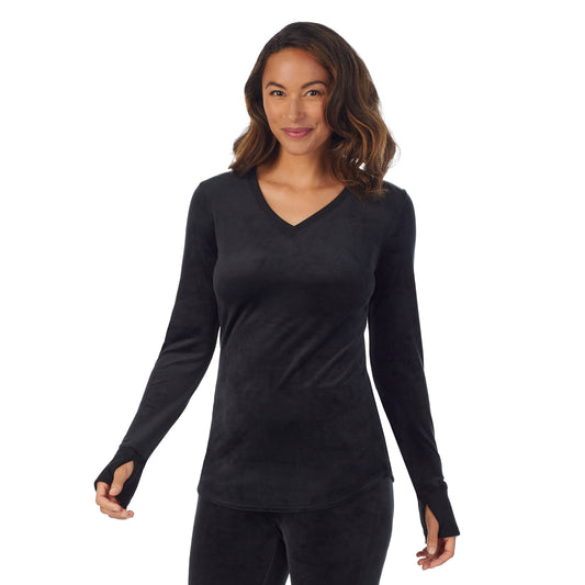A lady wearing black stretch velour long sleeve v-neck