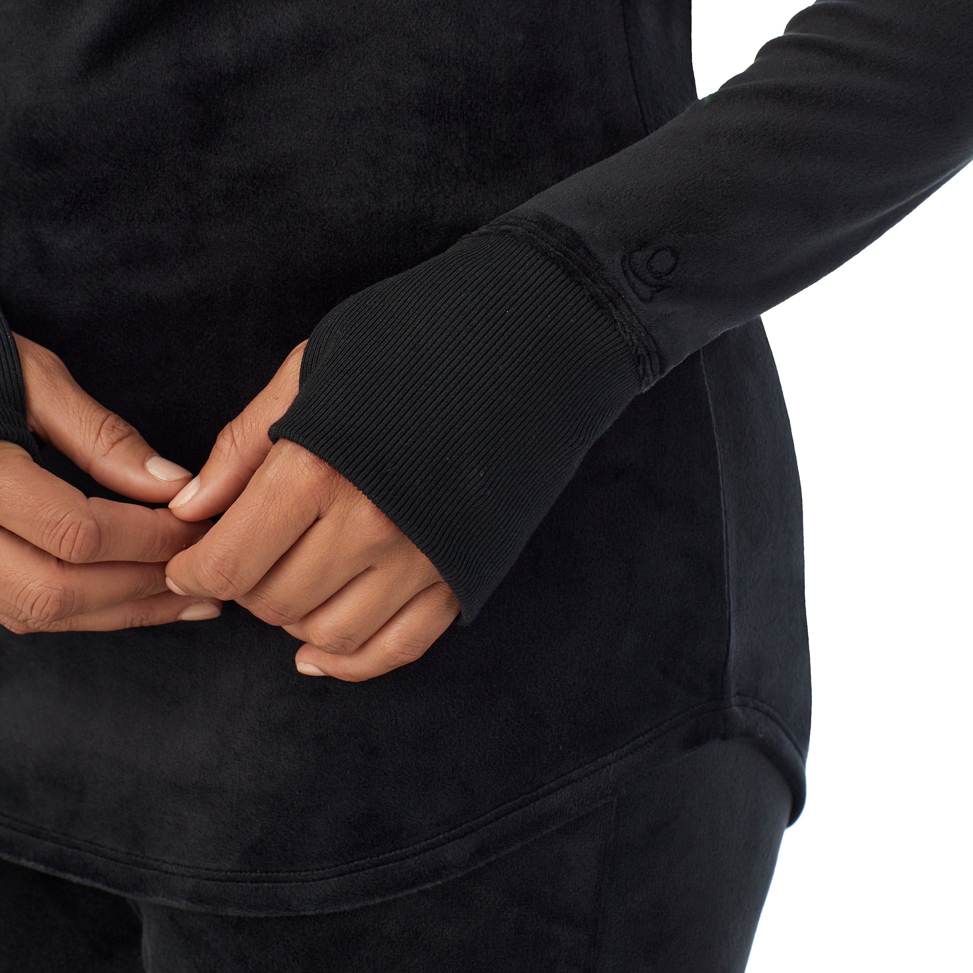 A lady wearing black stretch velour long sleeve v-neck
