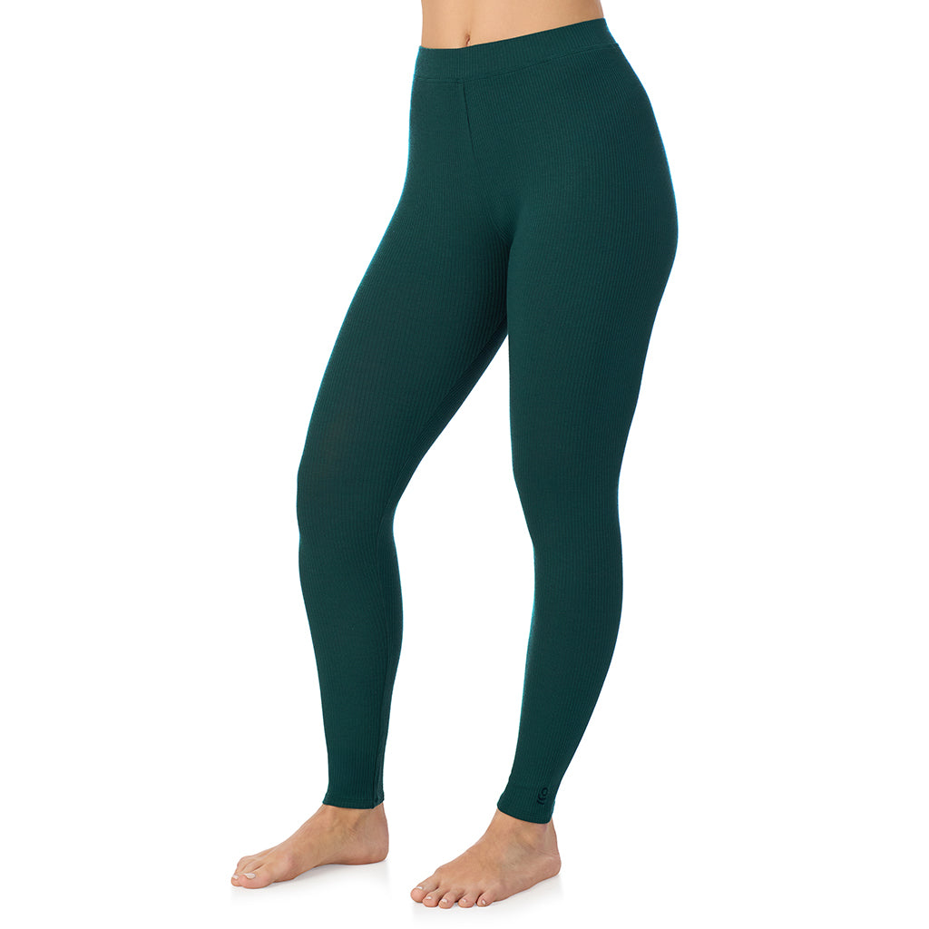 Dark Pine; Model is wearing size S. She is 5'11.5", Bust 34", Waist 26", Hips 37".@ A lady is wearing a Dark Pine Stretch Rib Legging