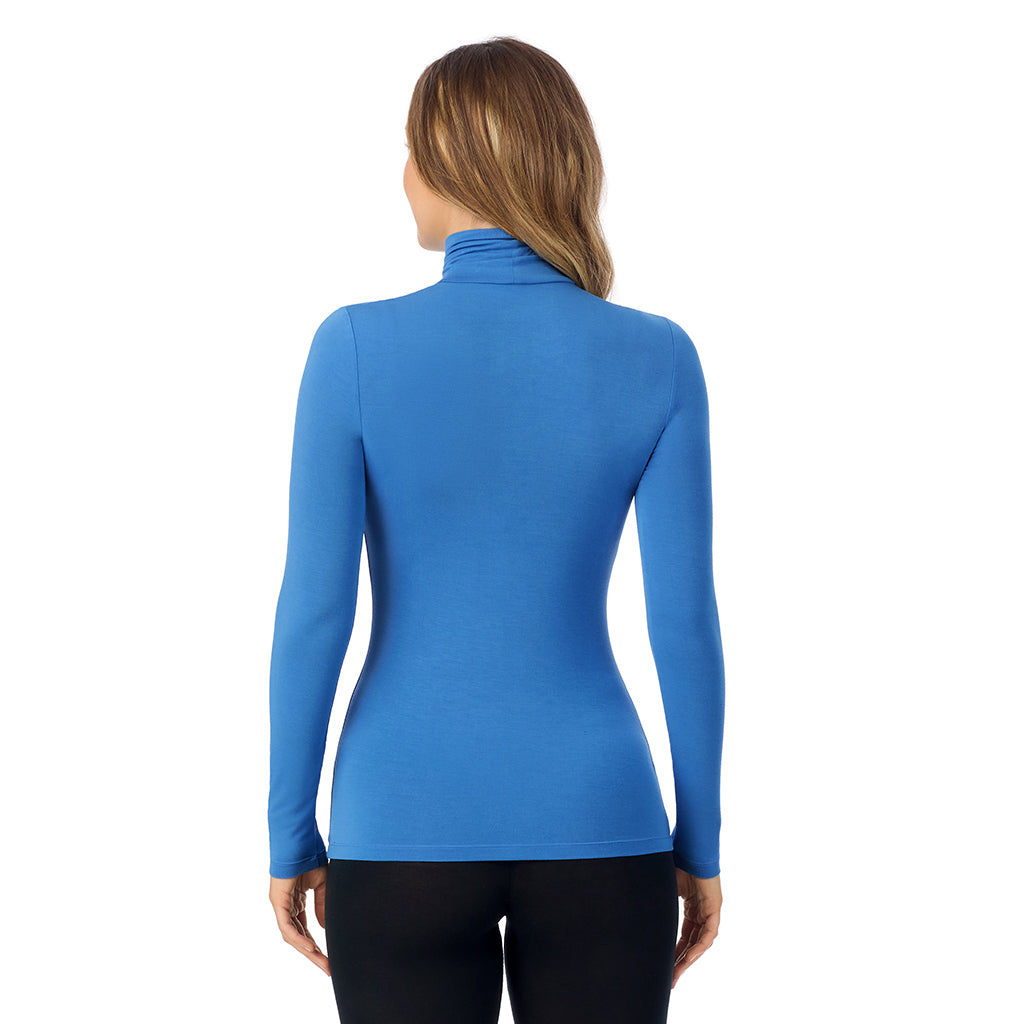 Blue Comet; Model is wearing size S. She is 5'11.5", Bust 34", Waist 26", Hips 37". @A lady wearing blue comet long sleeve turtleneck softwear with stretch top.