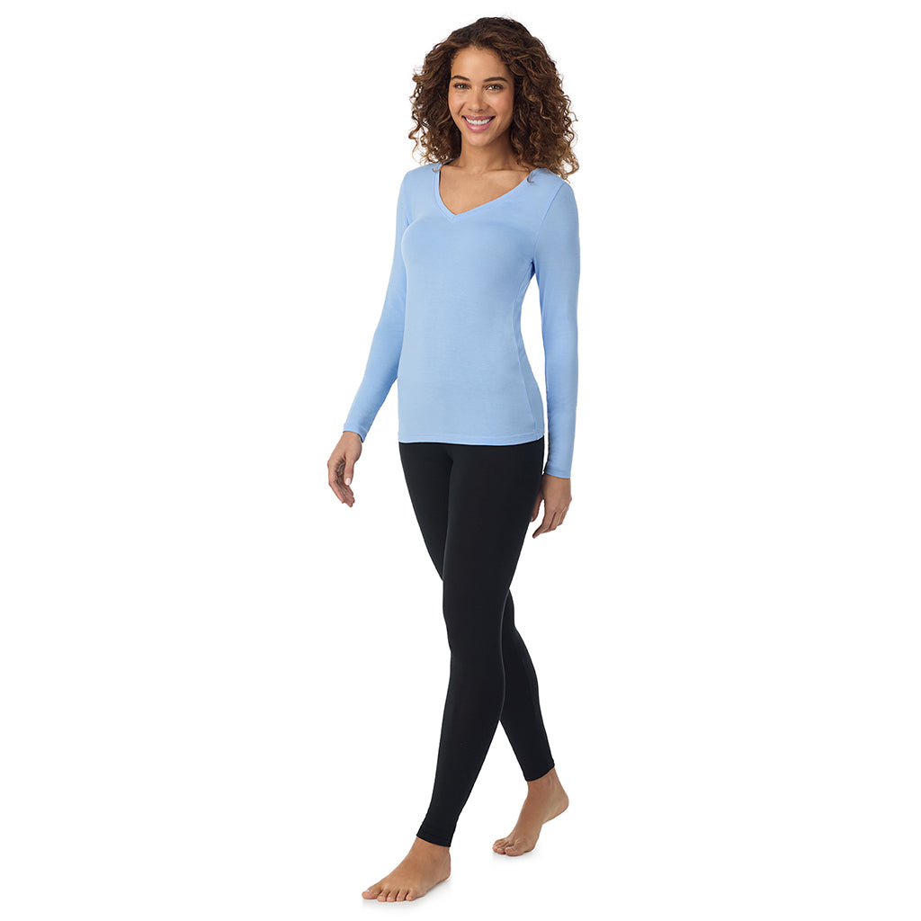 Vista Blue; Model is wearing size S. She is 5’9”, Bust 34”, Waist 23”, Hips 35”.@A lady wearing vista blue long sleeve softwear with stretch v-neck.