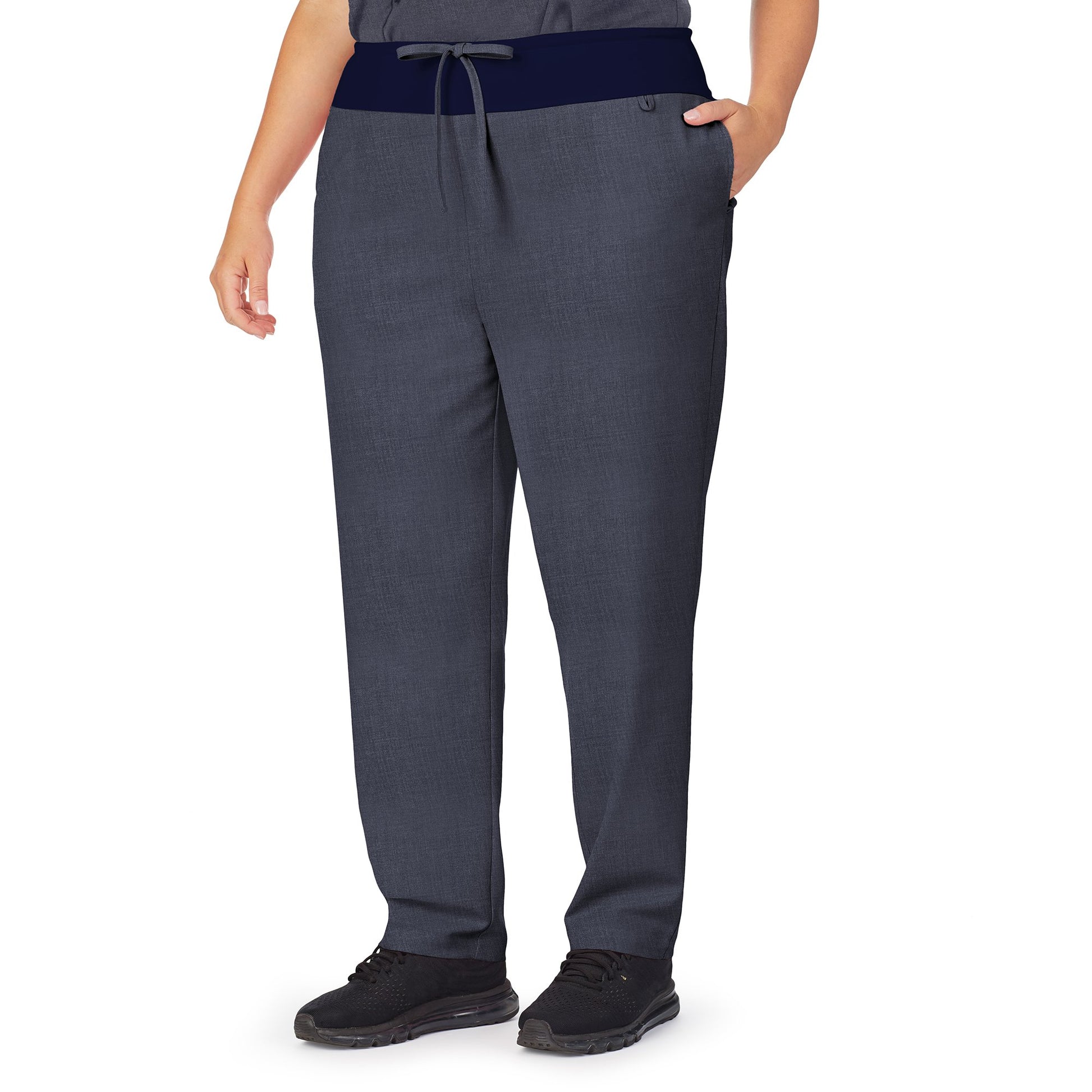 A lady wearing navy heather scrub classic pant plus.