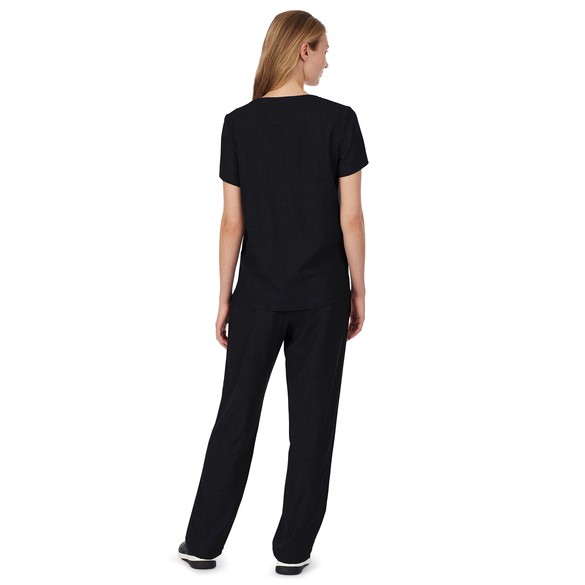 A lady wearing black scrub v-neck top with chest pocket petite.