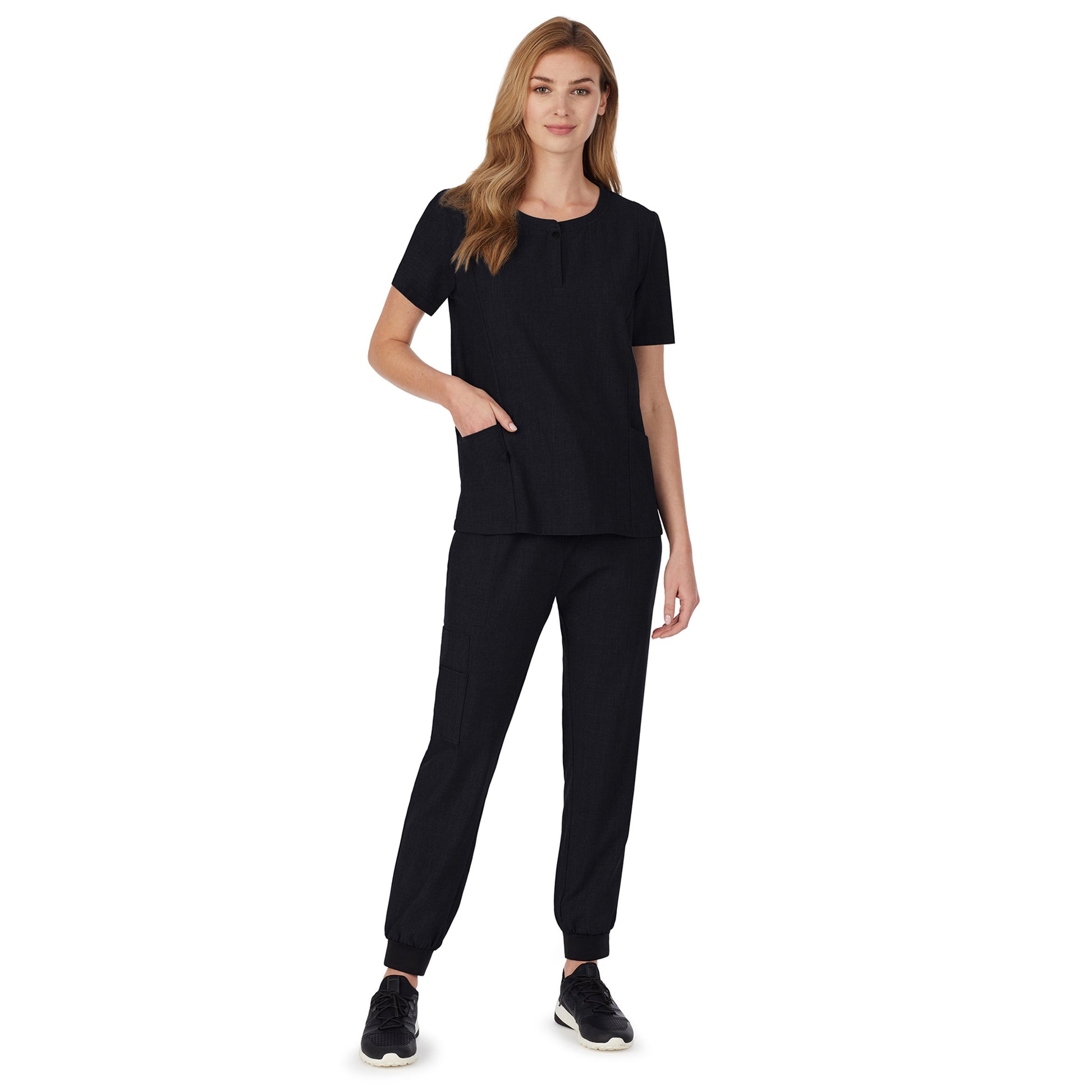 A lady wearing black scrub henley neck top with side pockets petite.
