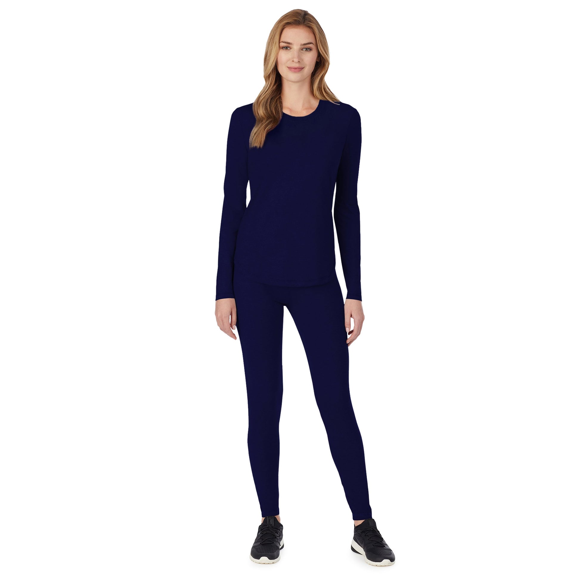 A lady wearing a navy long sleeve underscrub crew neck top.