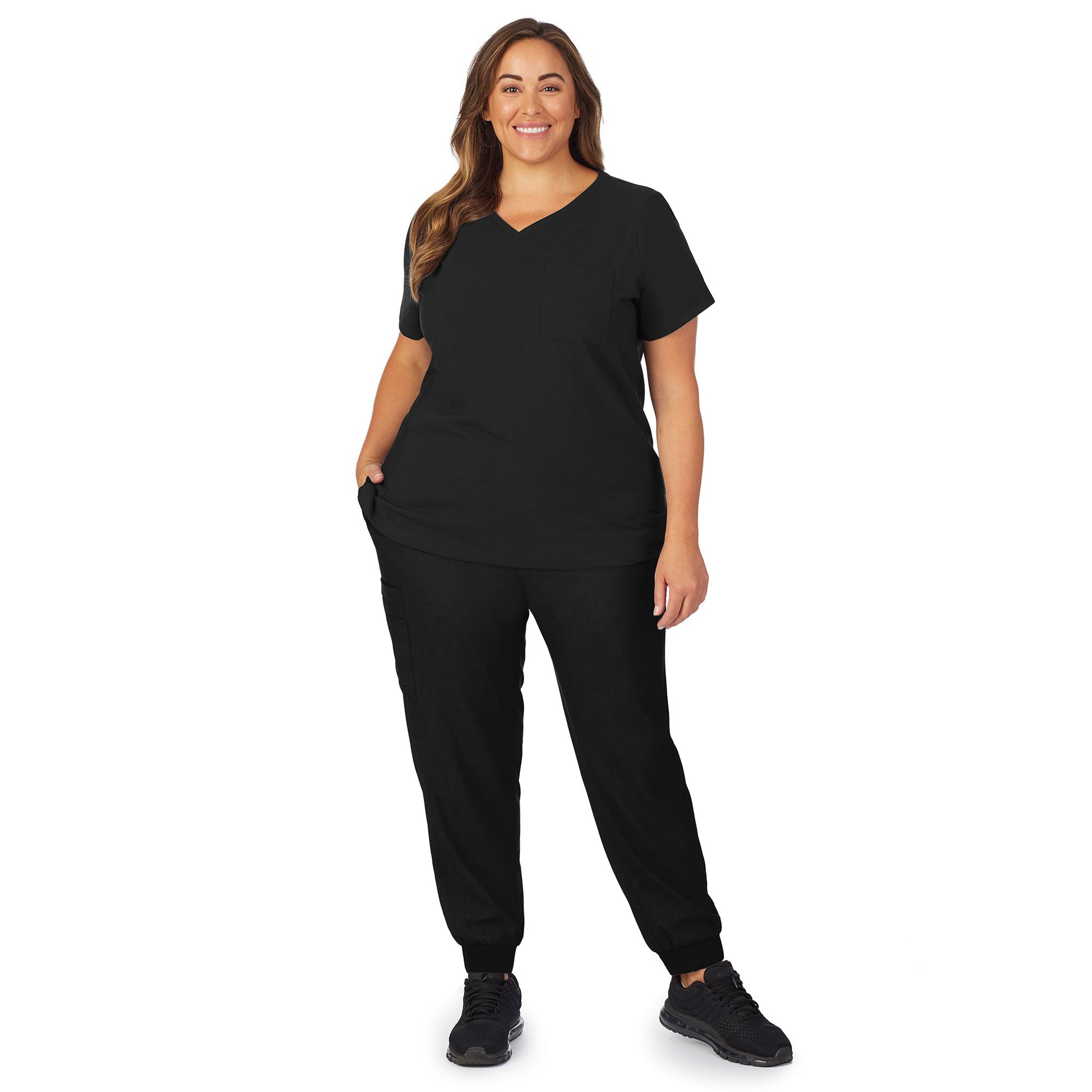 A lady wearing black scrub v-neck top with chest pocket plus.