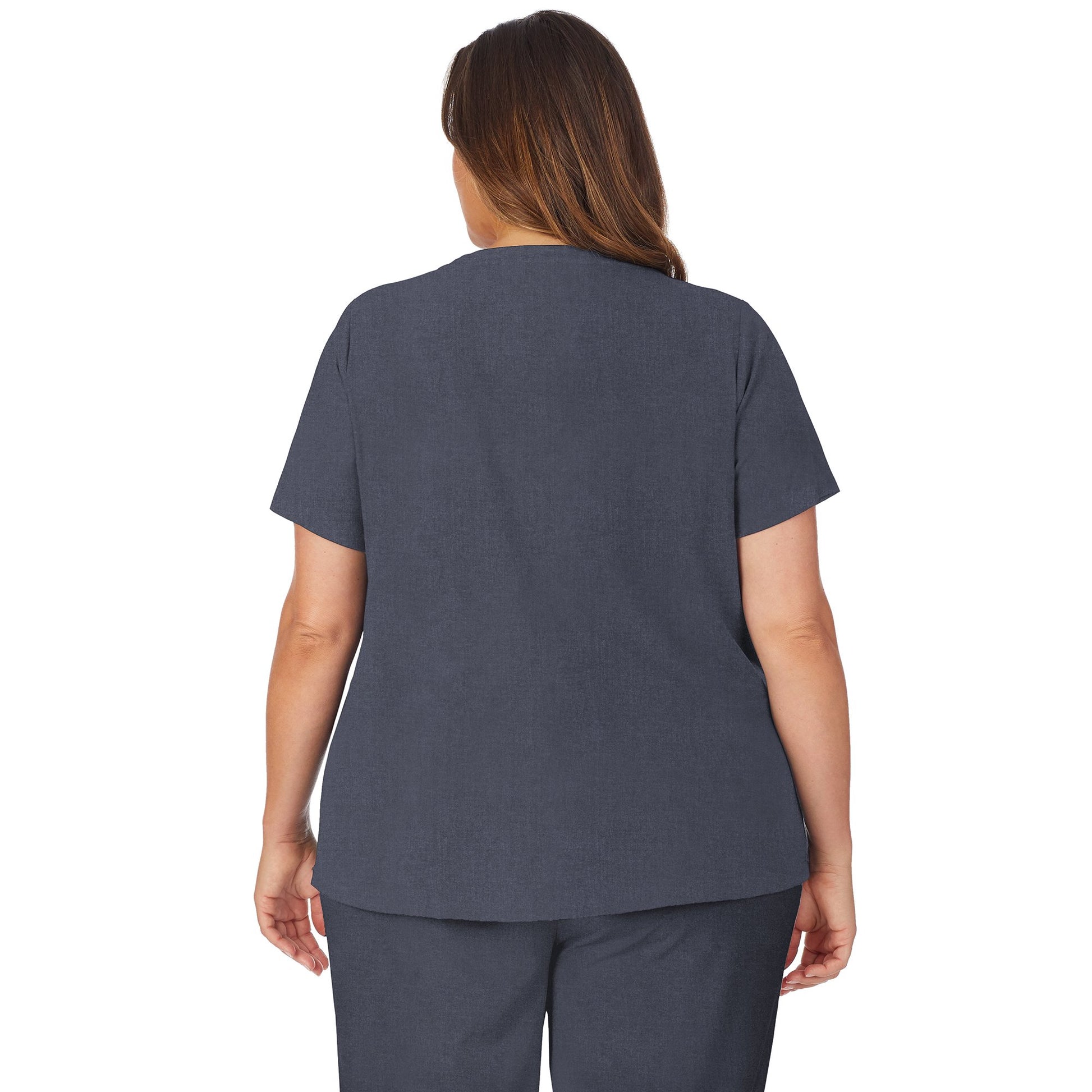 A lady wearing navy heather scrub v-neck top with side pockets plus.