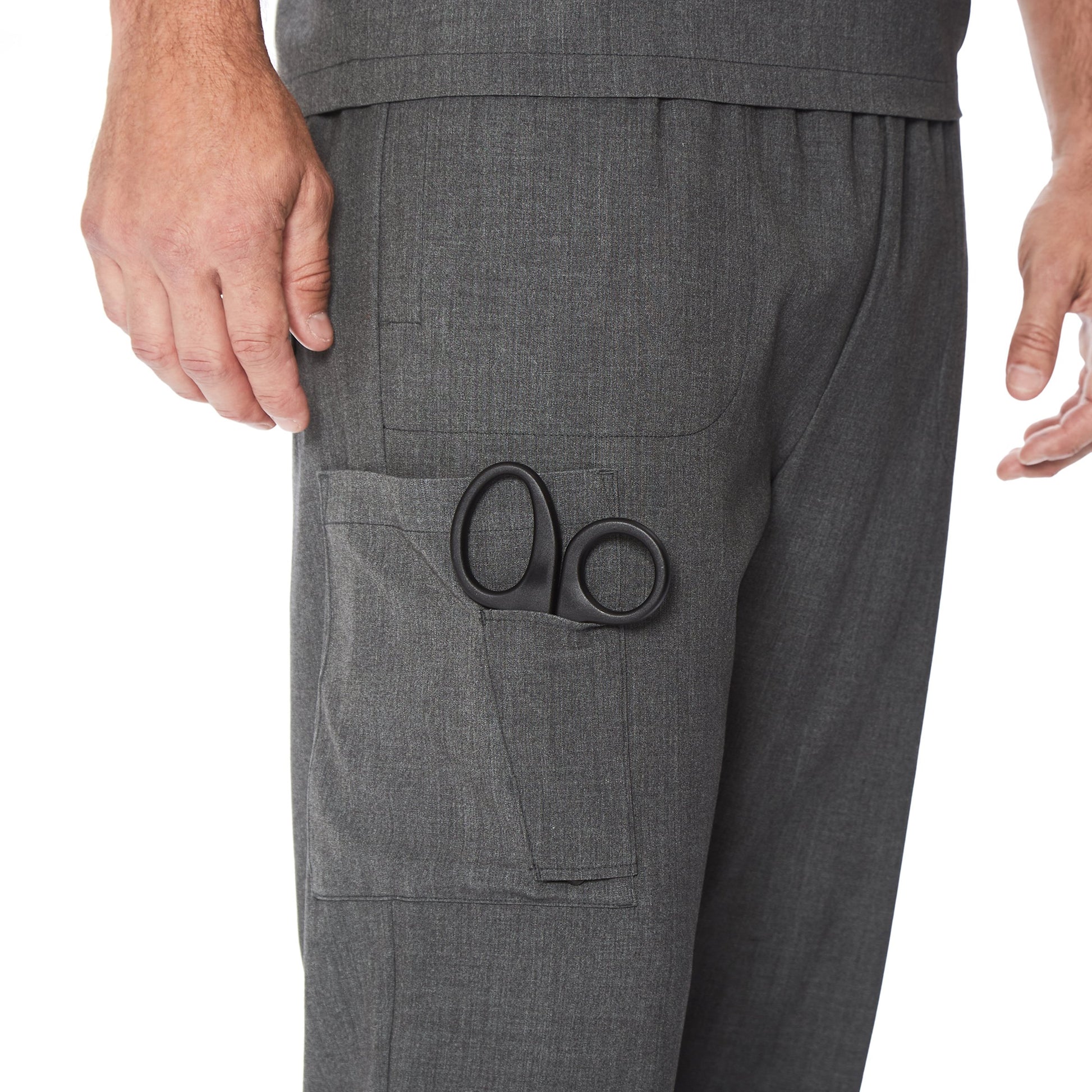 A man wearing a charcoal heather scrub jogger pant.