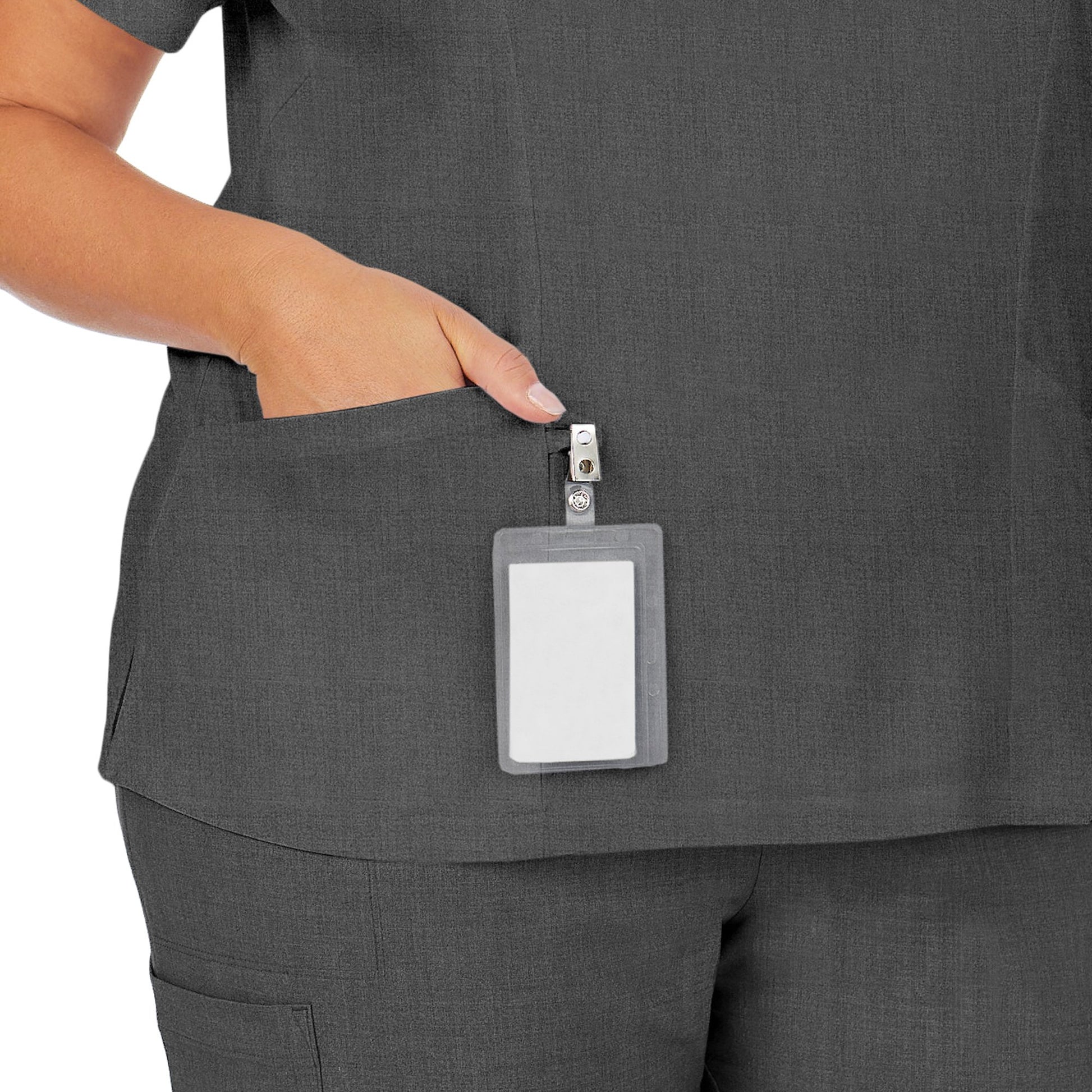 A lady wearing charcoal heather scrub henley neck top with side pockets plus.