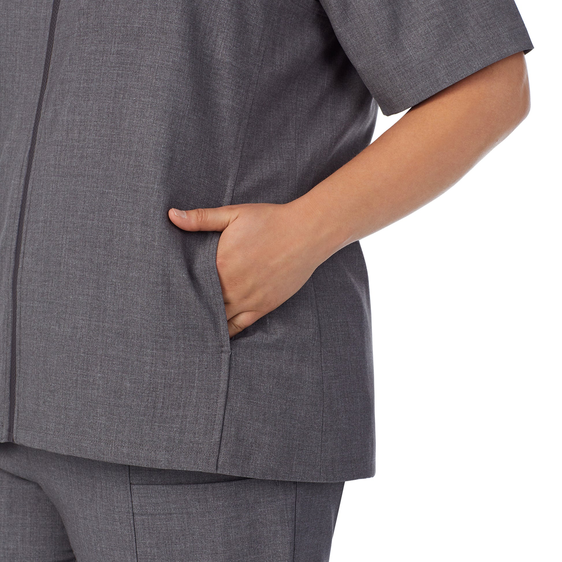 A lady wearing charcoal heather scrub vest plus.
