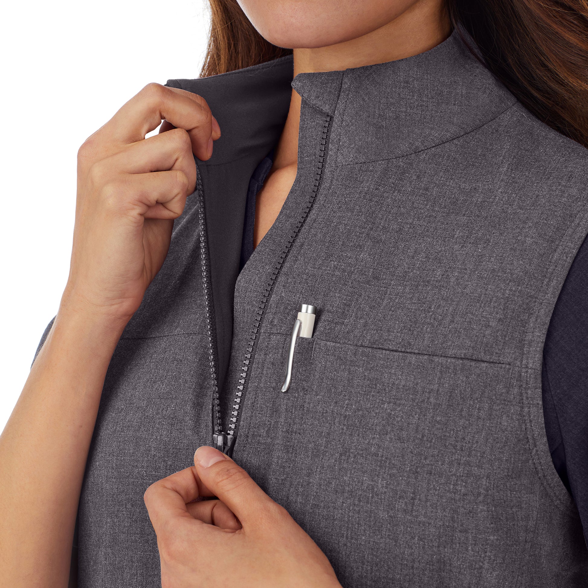 A lady wearing charcoal heather scrub vest.