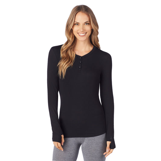 A lady wearing a black  ribbed long sleeve henley.