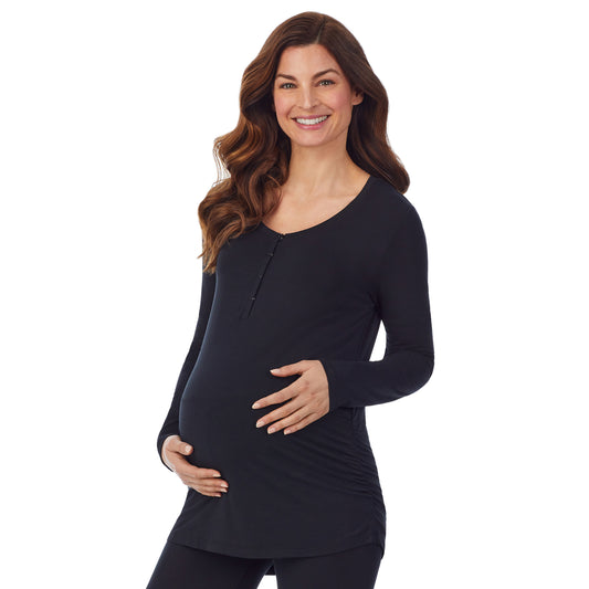 A lady wearing a black long sleeve maternity snap front henley top. #Model is wearing a maternity bump.