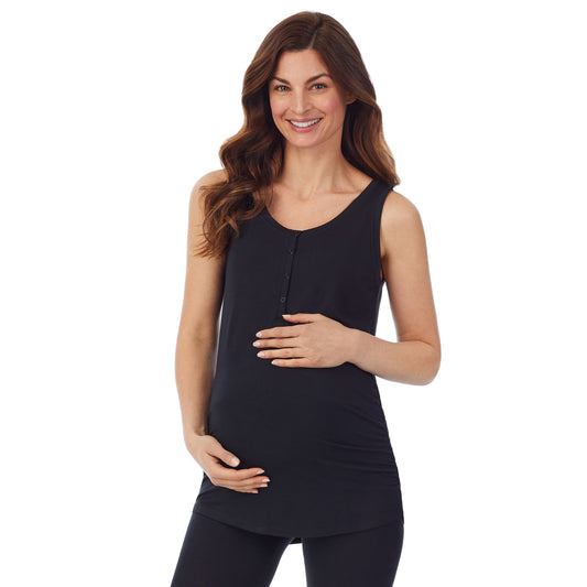 A lady wearing a black sleeveless maternity snap front henley tank top. #Model is wearing a maternity bump.