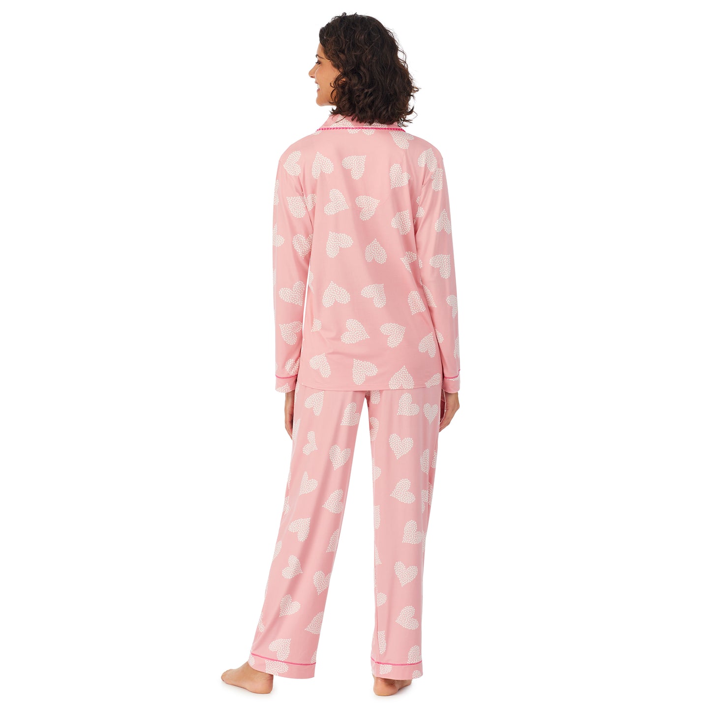 Pink Ground Hearts; Model is wearing size S. She is 5’9”, Bust 32”, Waist 24”, Hips 34.5”. @A lady wearing a pink long sleeve pajama set with white.