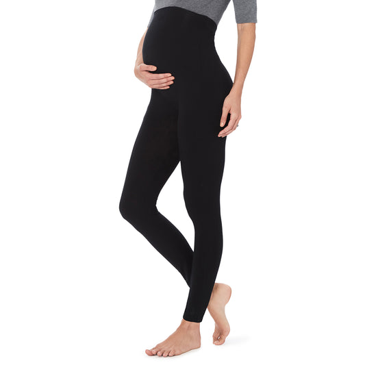 A lady wearing a black maternity legging. #Model is wearing a maternity bump.