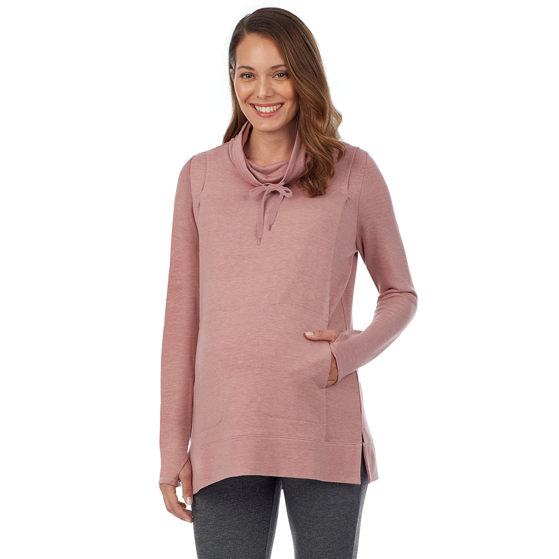 A lady wearing a pink taupe long sleeve funnel neck tunic. #Model is wearing a maternity bump.