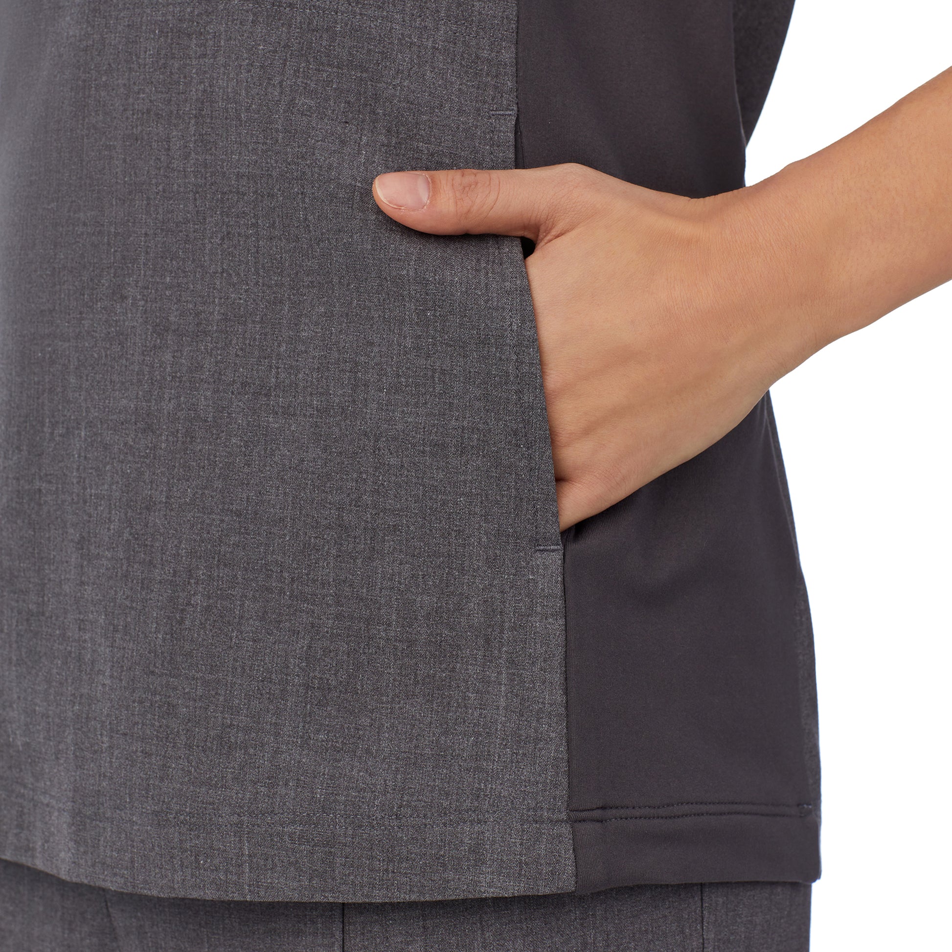 A lady wearing charcoal heather scrub split neck top.
