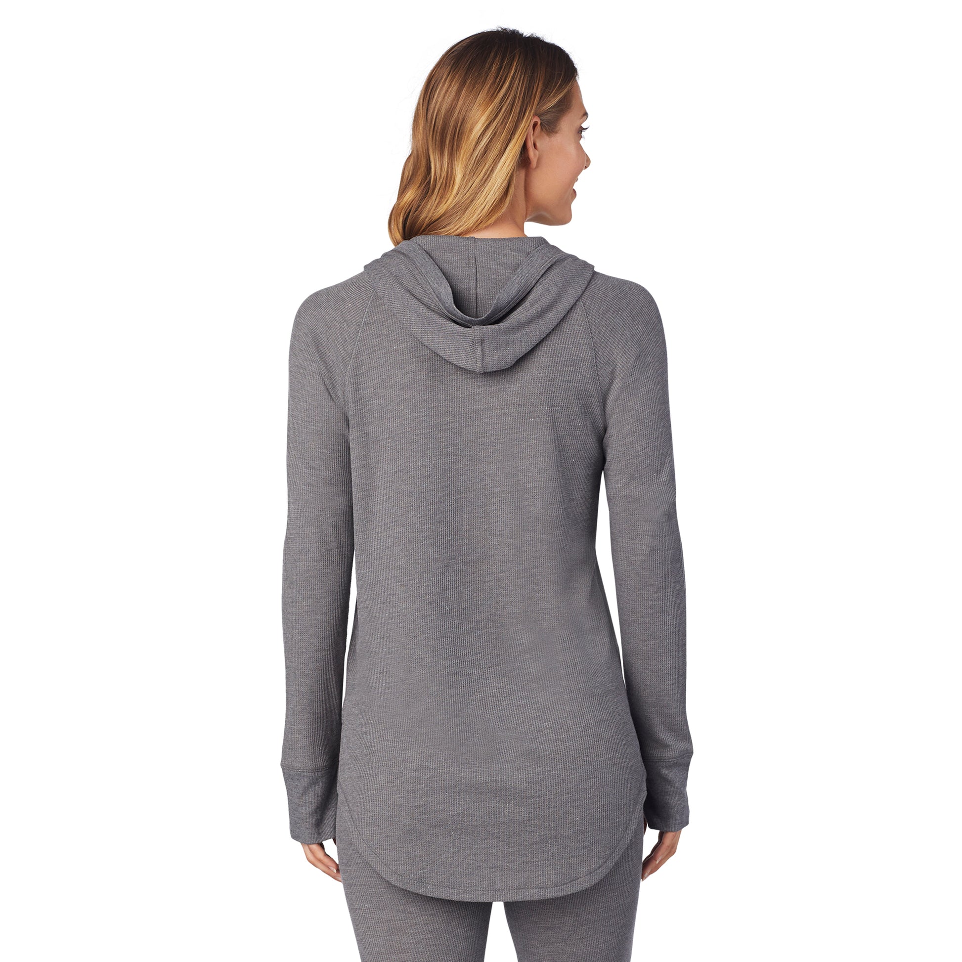 A lady wearing a stone grey heather long sleeve hoodie tunic.