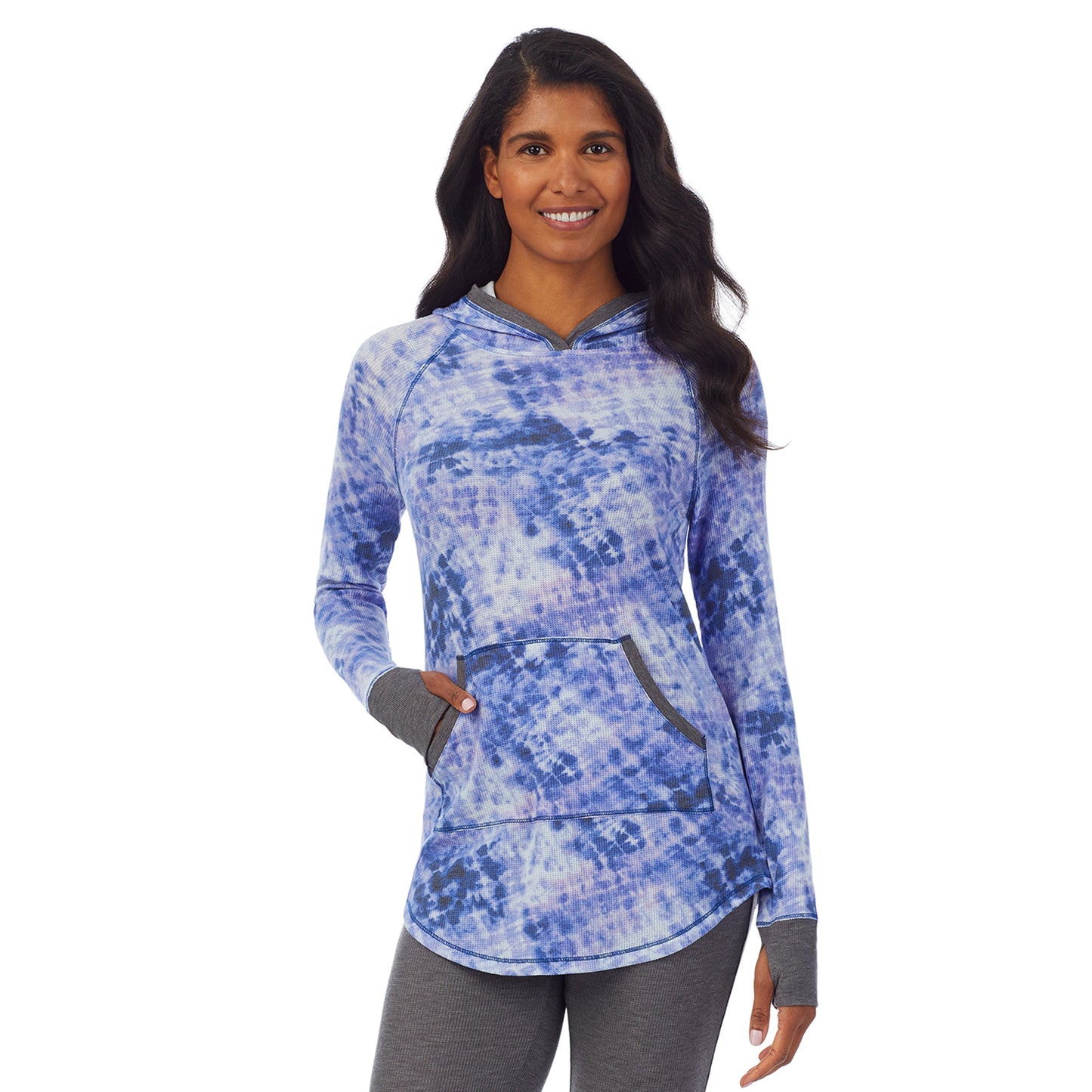 Blue Tie Dye; Model is wearing size S. She is 5’10”, Bust 34”, Waist 24”, Hips 34”. @A lady wearing a blue tie dye long sleeve hoodie tunic.