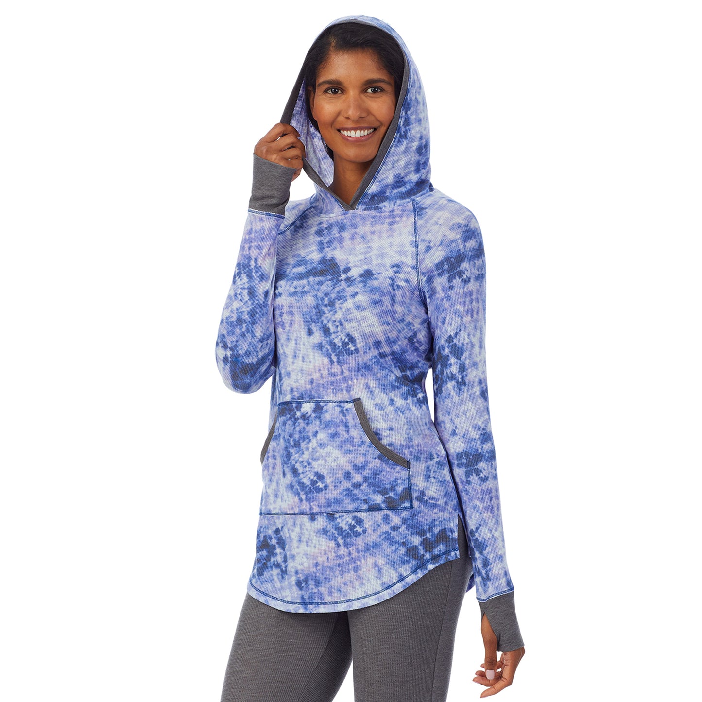 Blue Tie Dye; Model is wearing size S. She is 5’10”, Bust 34”, Waist 24”, Hips 34”. @A lady wearing a blue tie dye long sleeve hoodie tunic.
