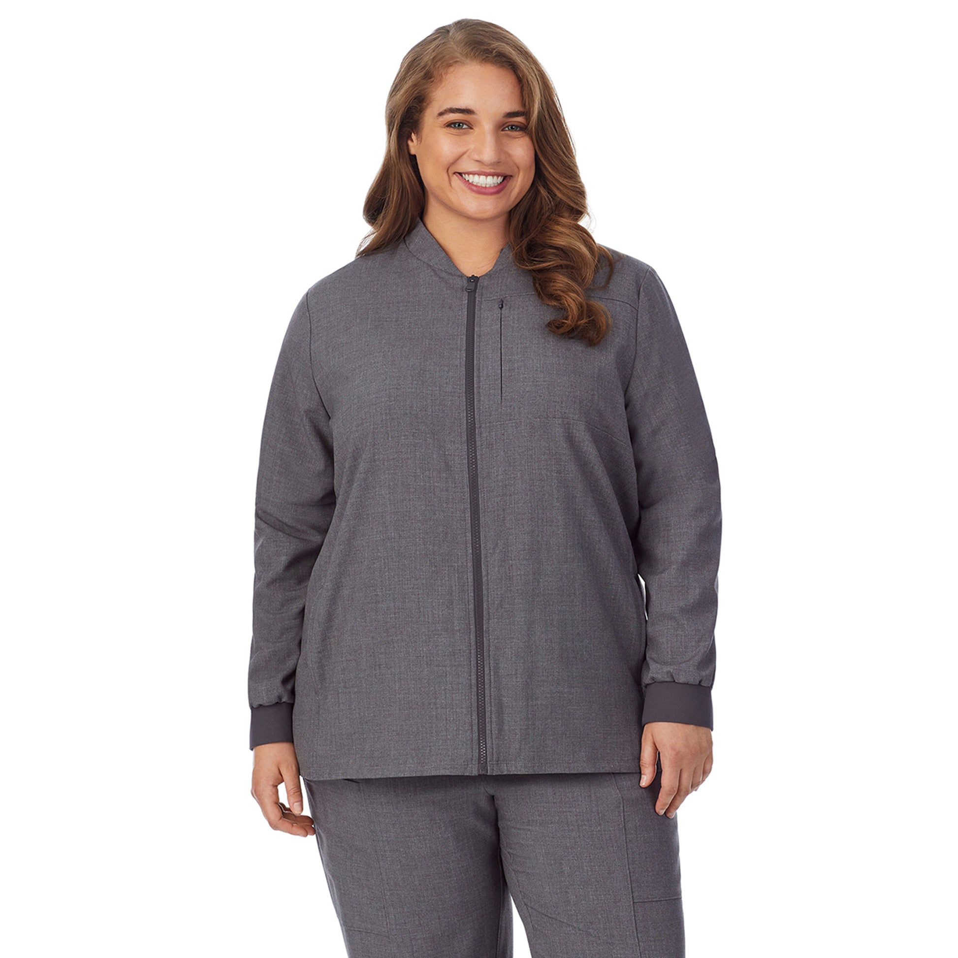 A lady wearing charcoal heather scrub jacket plus.