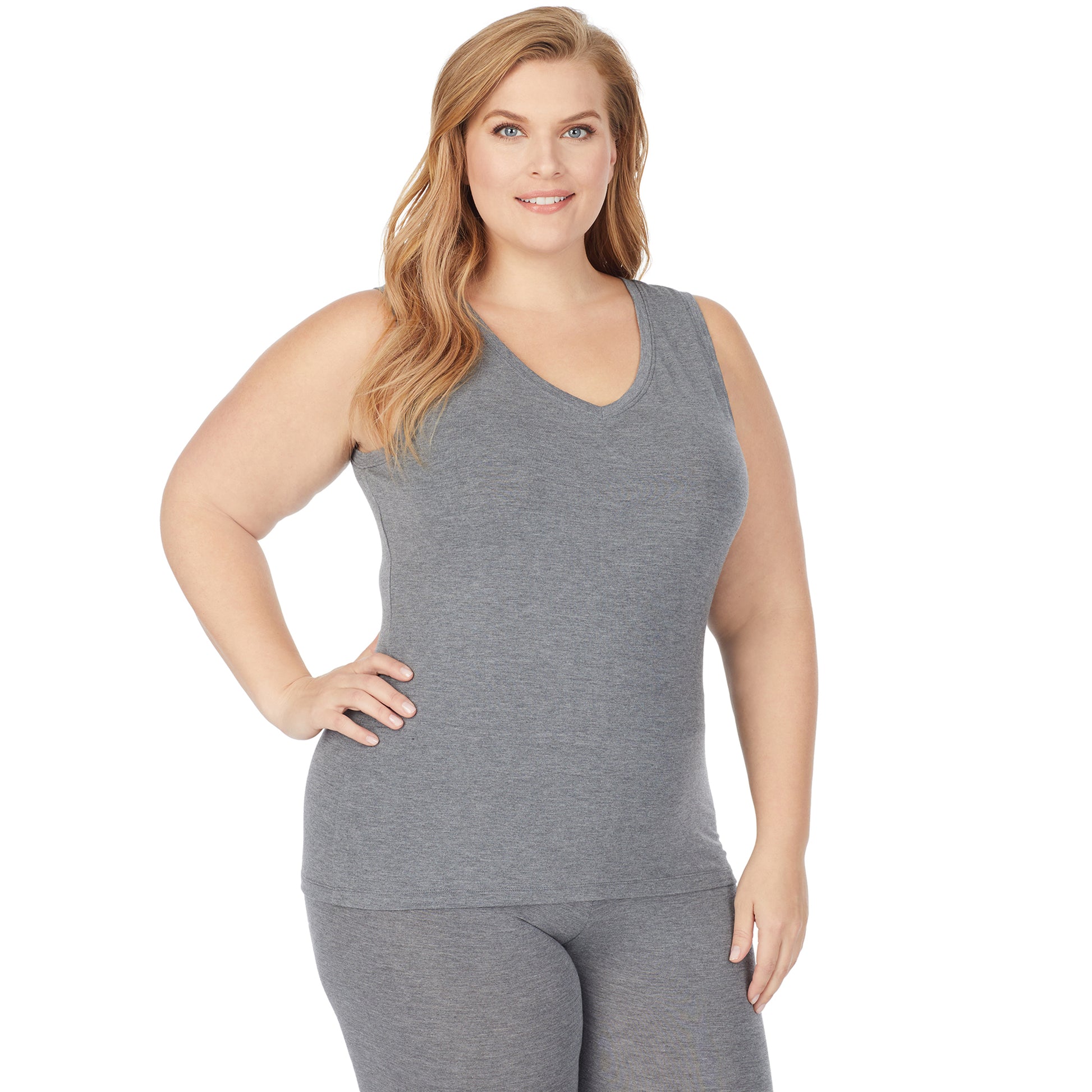 A lady wearing a charcoal heather sleeveless reversible tank plus.