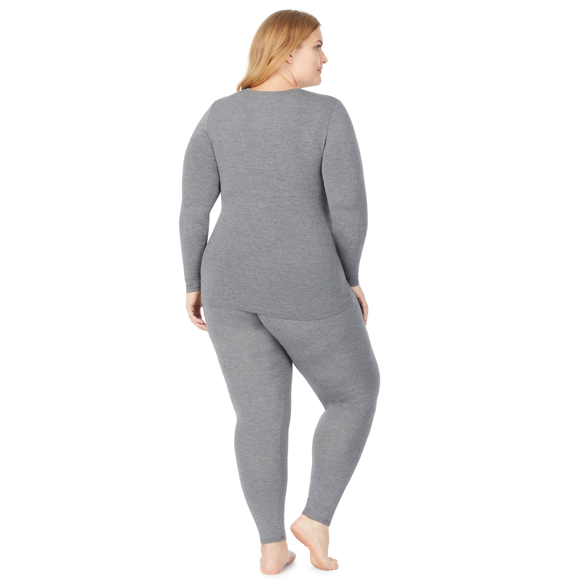 A lady wearing a charcoal heather stretch legging plus.