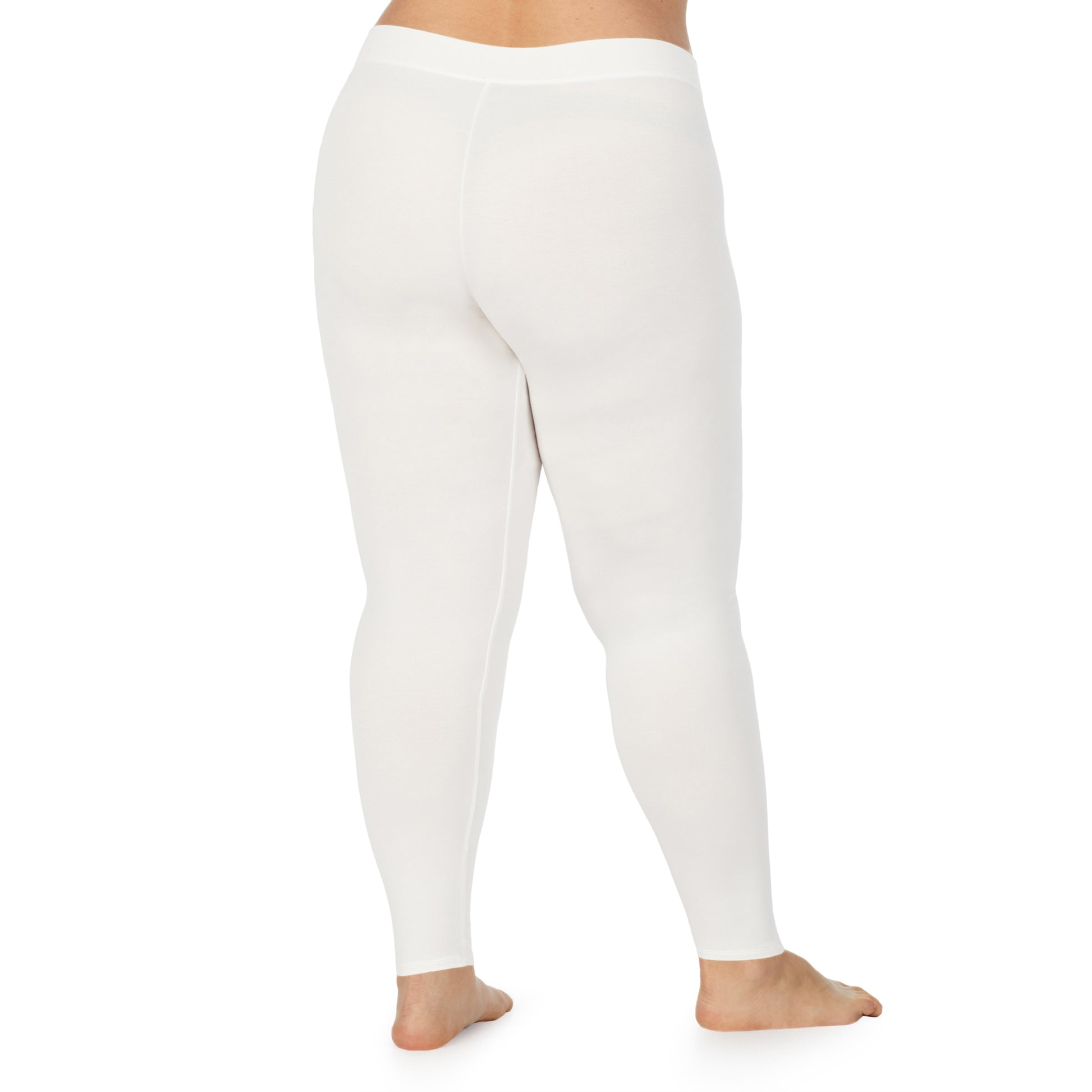 A lady wearing a ivory stretch legging plus.