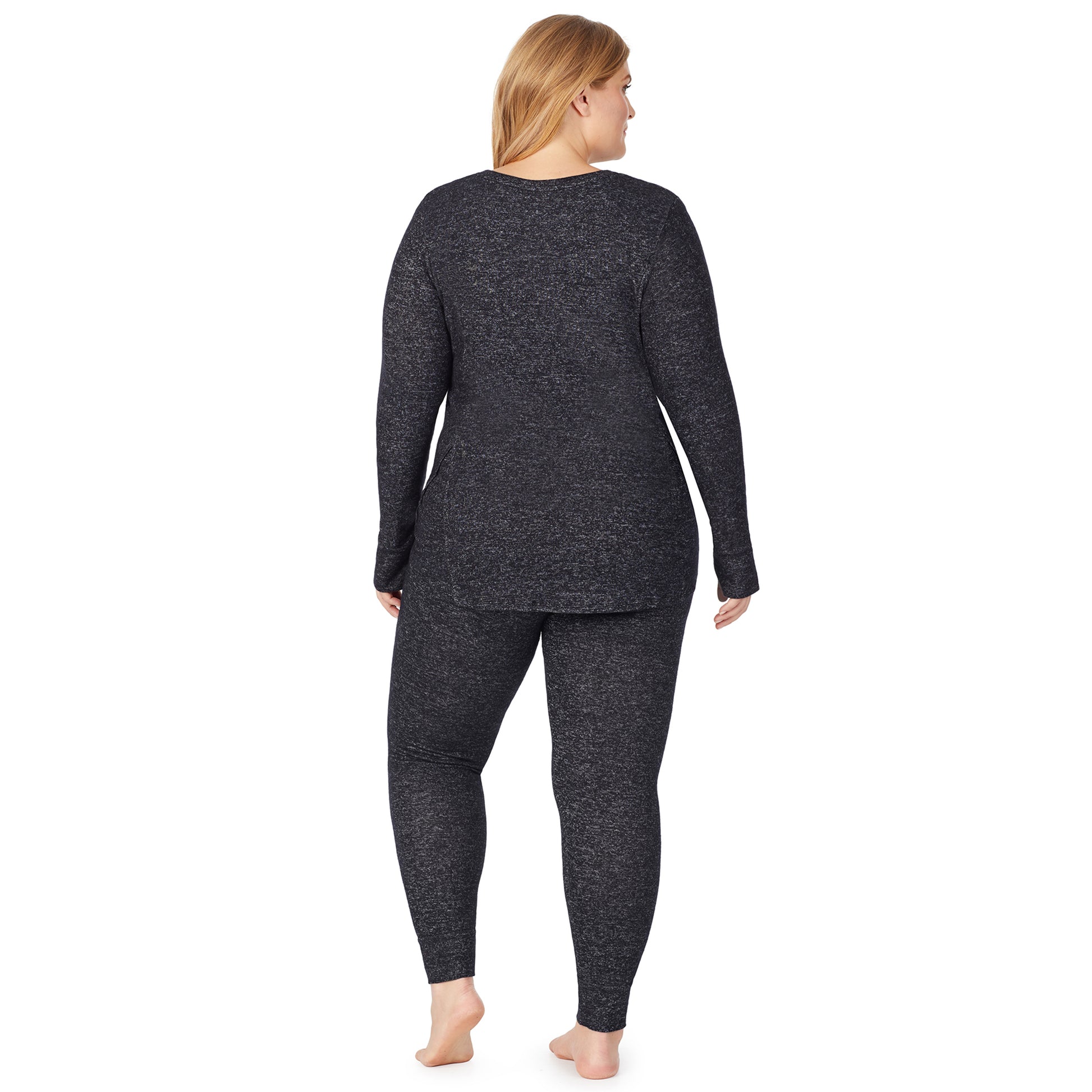 A lady wearing a marled dark charcoal legging plus.