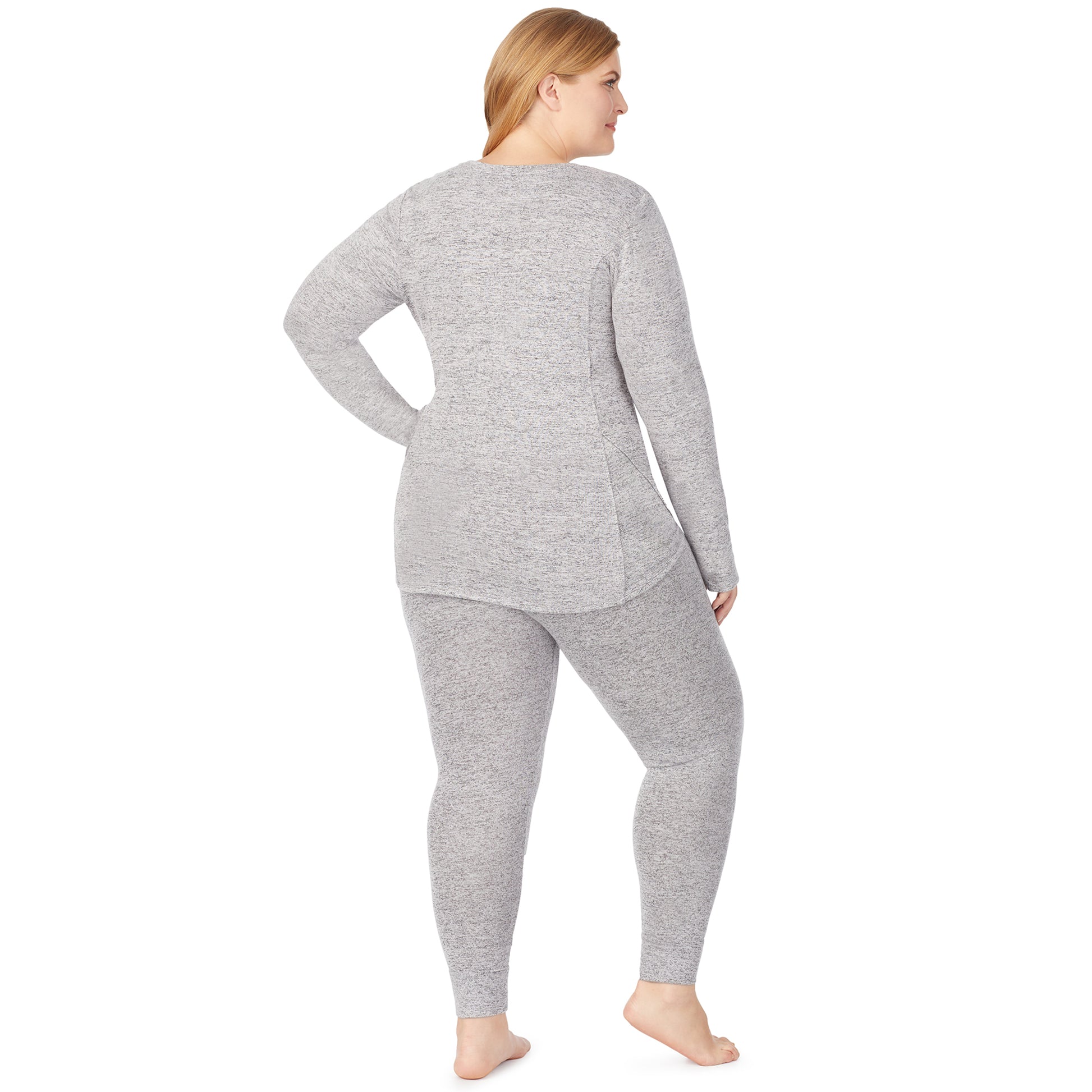A lady wearing a marled grey legging plus.