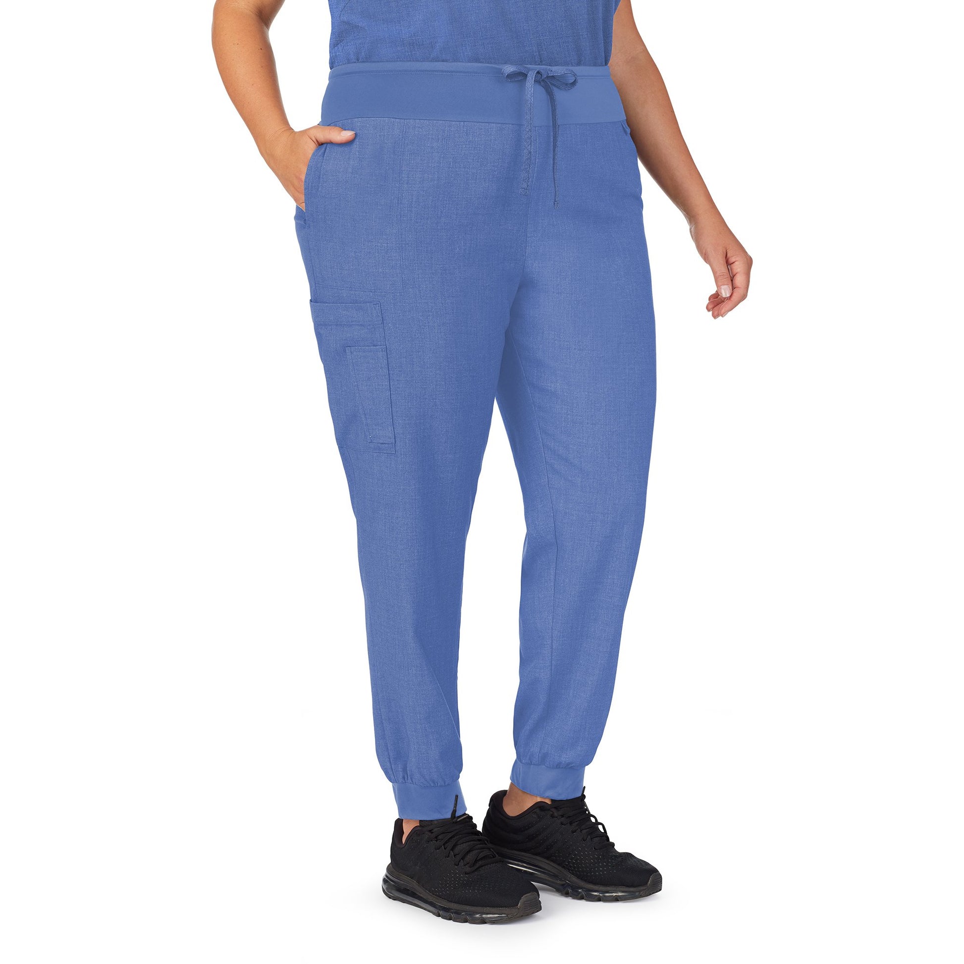 A lady wearing ceil heather scrub jogger pant plus.