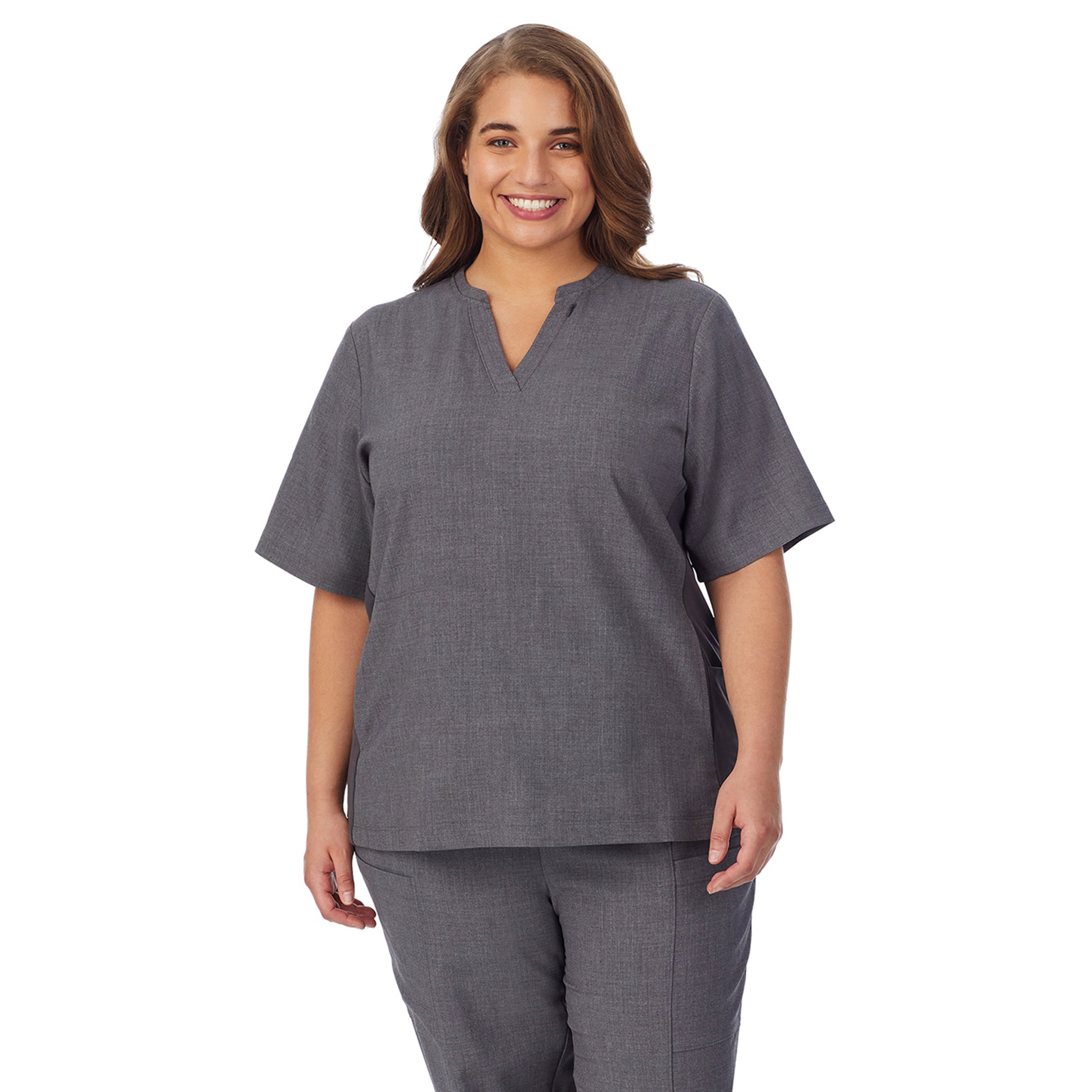 A lady wearing charcoal heather scrub split neck top plus.
