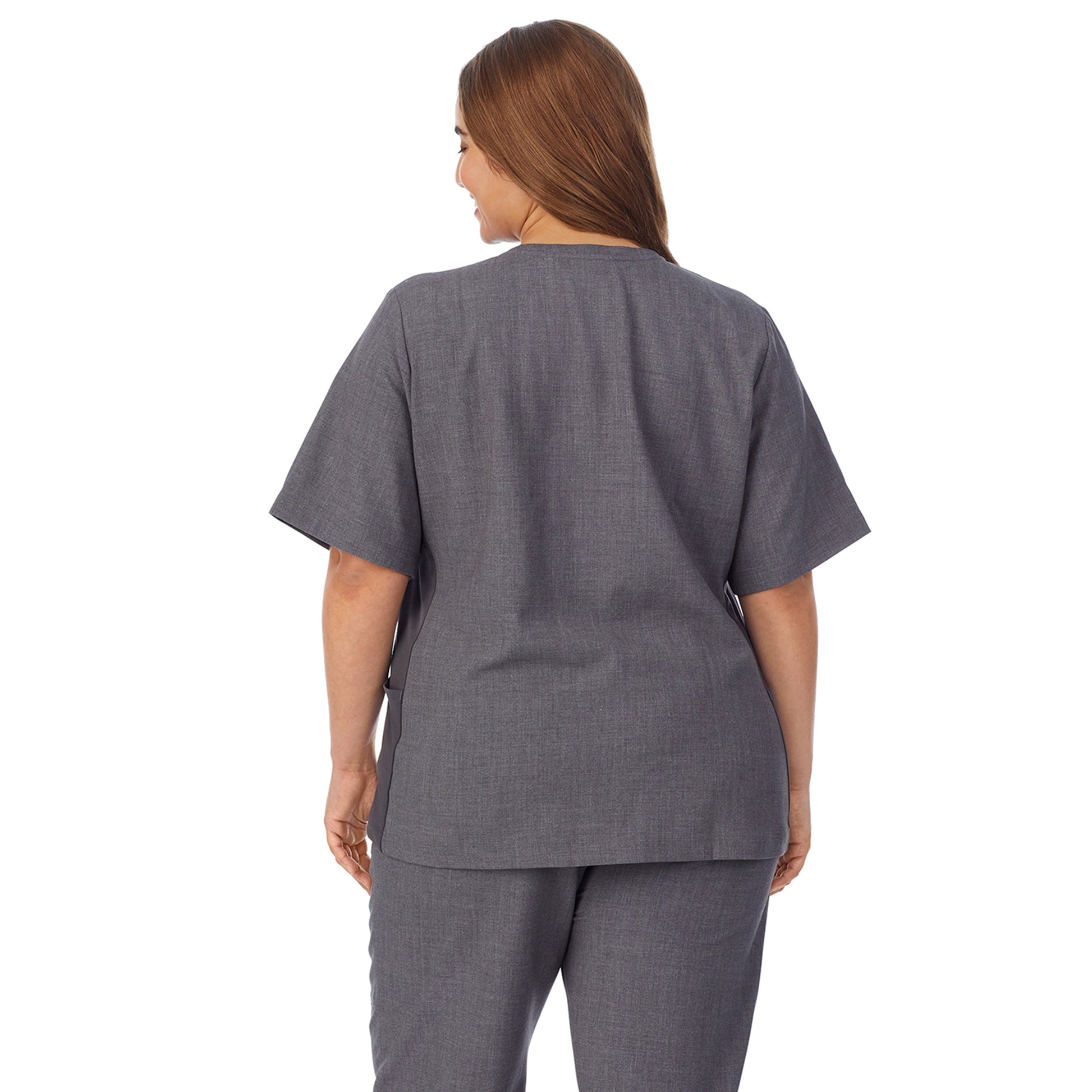 A lady wearing charcoal heather scrub split neck top plus.