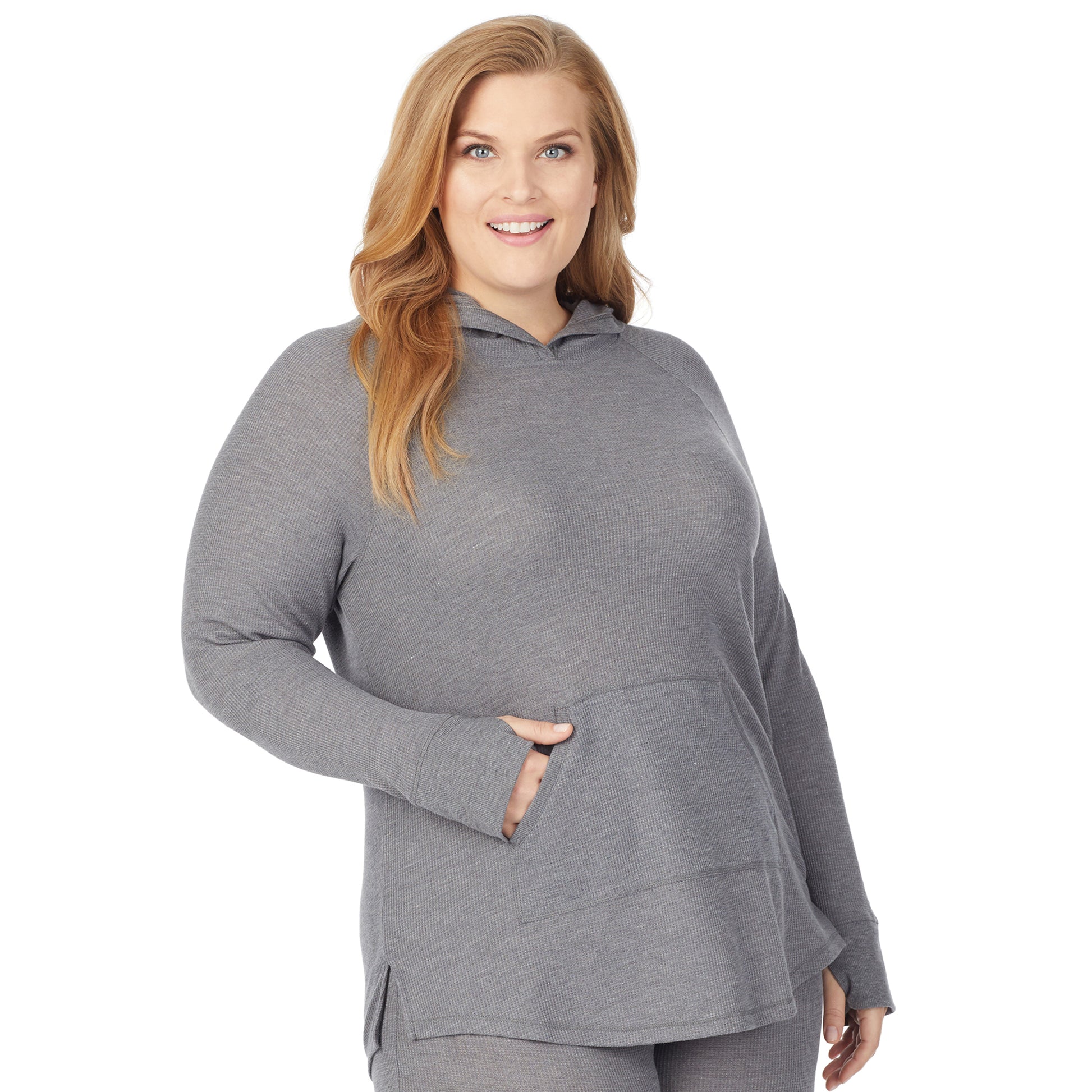 A lady wearing a stone grey heather long sleeve hoodie tunic plus.