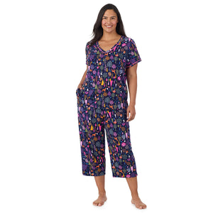 A lady wearing Cotton-Blend Short Sleeve Top with Cropped Pant Pajama Set PLUS in Navy Woodland