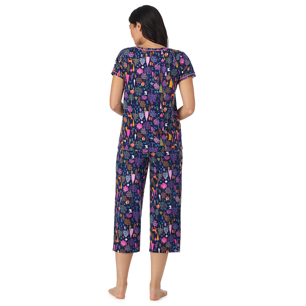 A lady wearing Cotton-Blend Short Sleeve Top with Cropped Pant Pajama Set in Navy Woodland back view