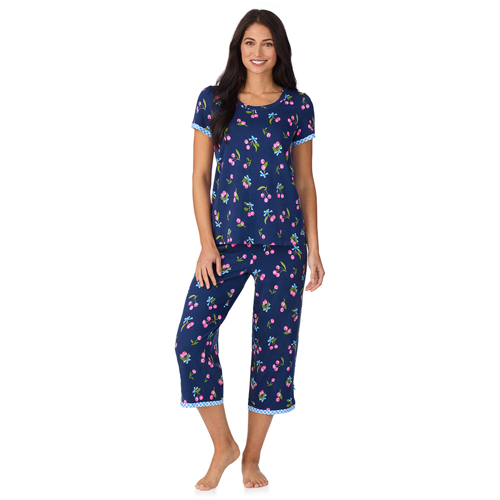 A lady wearing Cotton-Blend Short Sleeve Top with Cropped Pant 2-Pc Pajama Set in Navy Cherry Bow