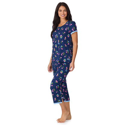 A lady wearing Cotton-Blend Short Sleeve Top with Cropped Pant 2-Pc Pajama Set in Navy Cherry Bow