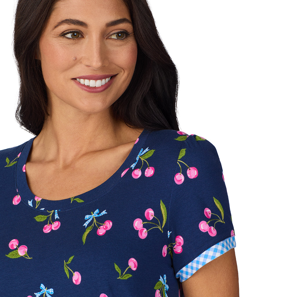 Navy Cherry Bow; Model is wearing size S. She is 5'8.5", Bust 32", Waist 25", Hips 36". @A lady wearing Cotton-Blend Short Sleeve Top with Cropped Pant 2-Pc Pajama Set in Navy Cherry Bow