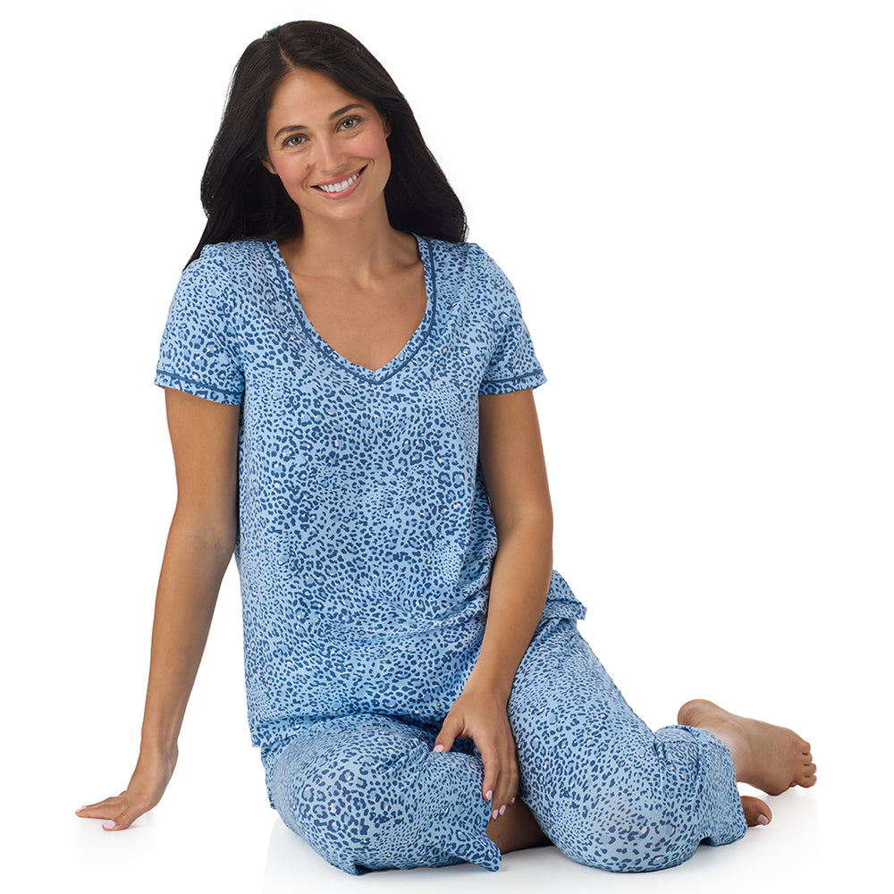 A lady wearing Cotton-Blend Short Sleeve Top with Cropped Pant Pajama Set in Blue Animal sitting down