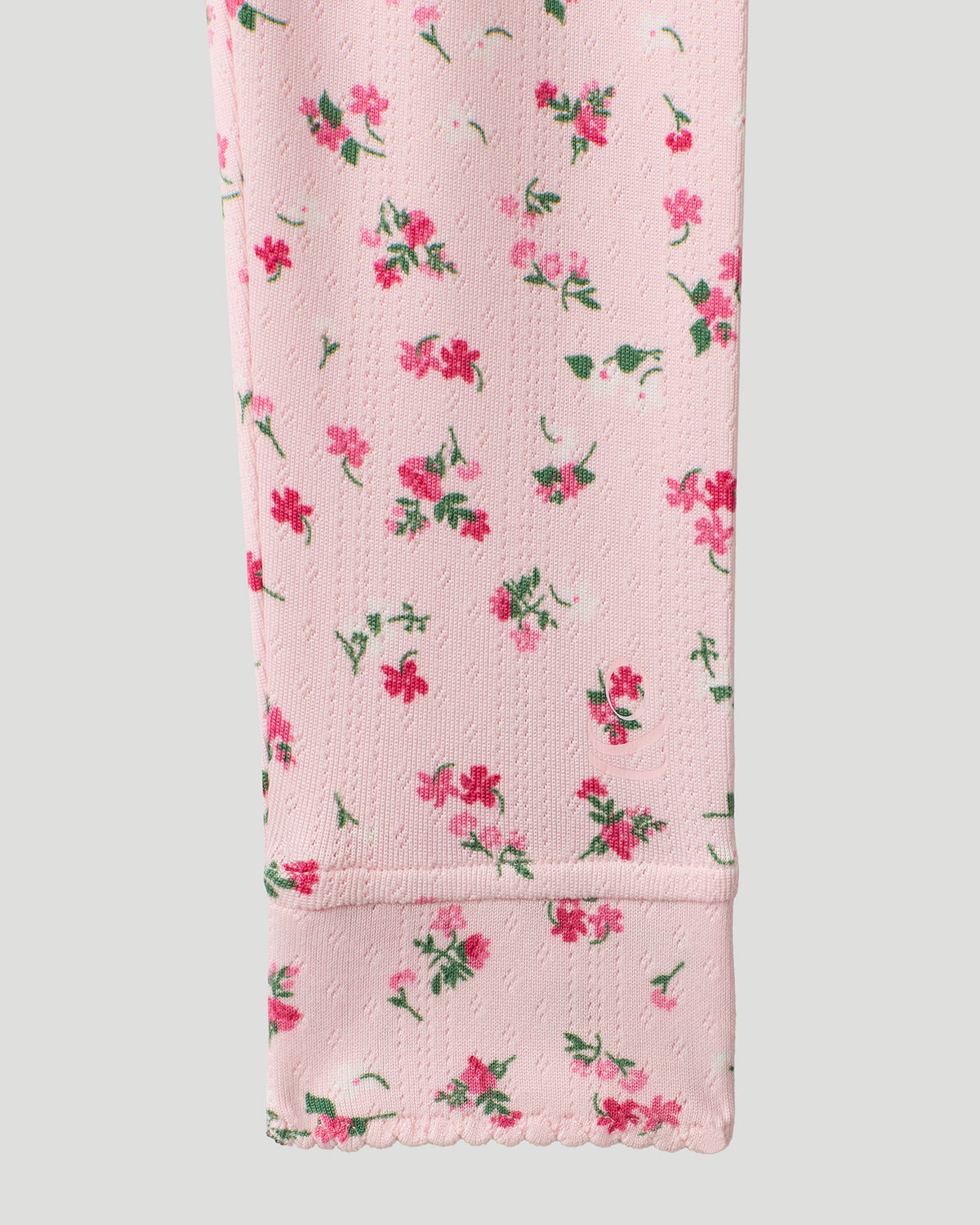 A Pink Ditsy Floral Girls Pointelle Knit 2 pc. Long Sleeve Crew &amp; Pant Set featured in a detail close up shot of the sleeve hem