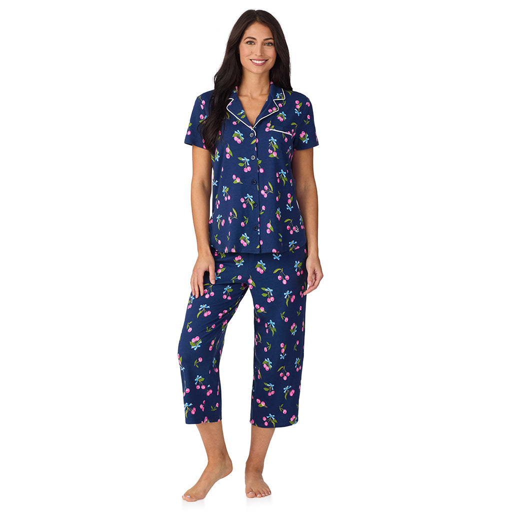 Navy Cherry Bow; Model is wearing size S. She is 5'8.5", Bust 32", Waist 25", Hips 36". @A lady wearing Cotton-Blend Short Sleeve Notch Collar with Cropped Pant 2-Pc Pajama Set in Navy Cherry Bow