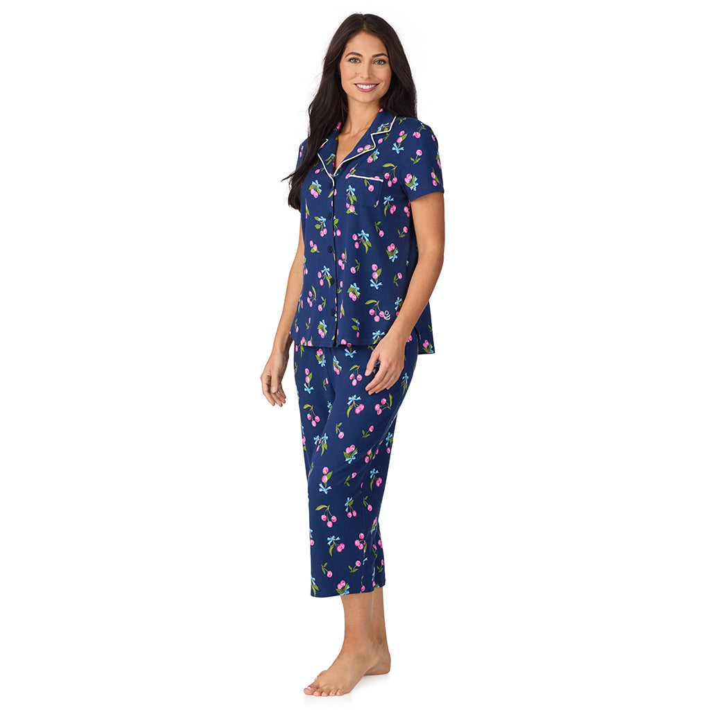 A lady wearing Cotton-Blend Short Sleeve Notch Collar with Cropped Pant 2-Pc Pajama Set in Navy Cherry Bow